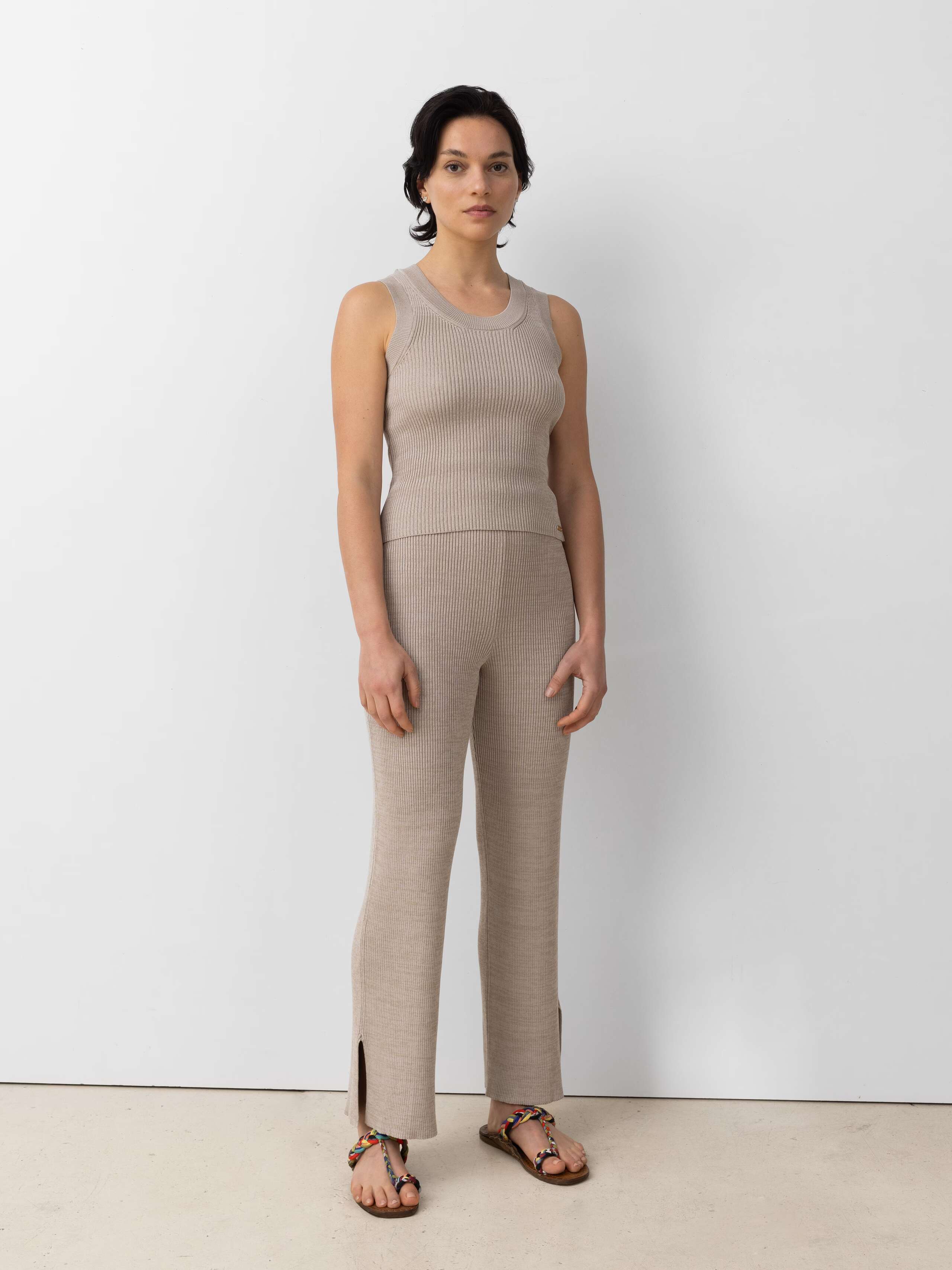 Model wearing the Emma trousers in a beige cotton knit