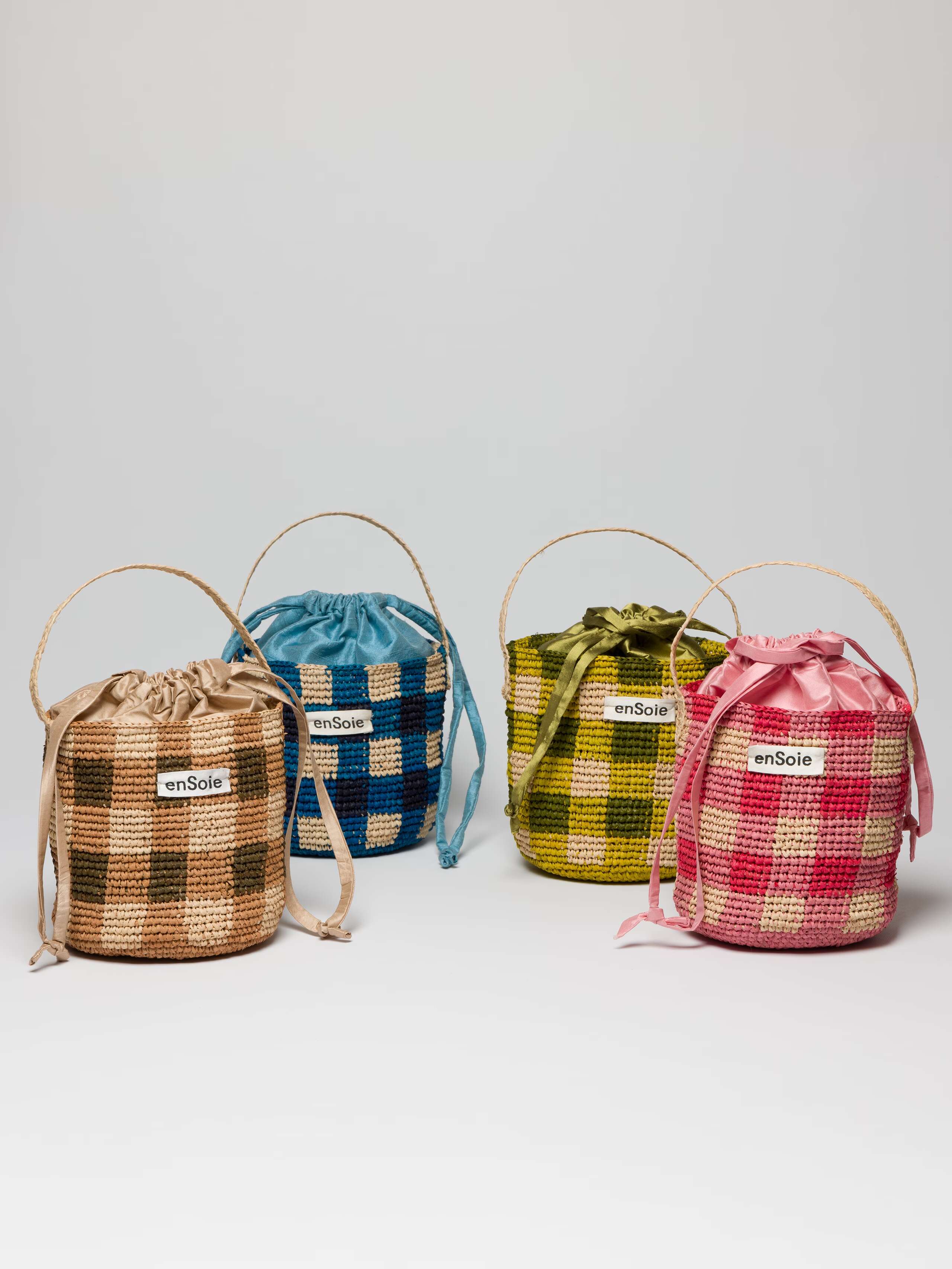 Four colourful basket bags made from natural Raffia fabric