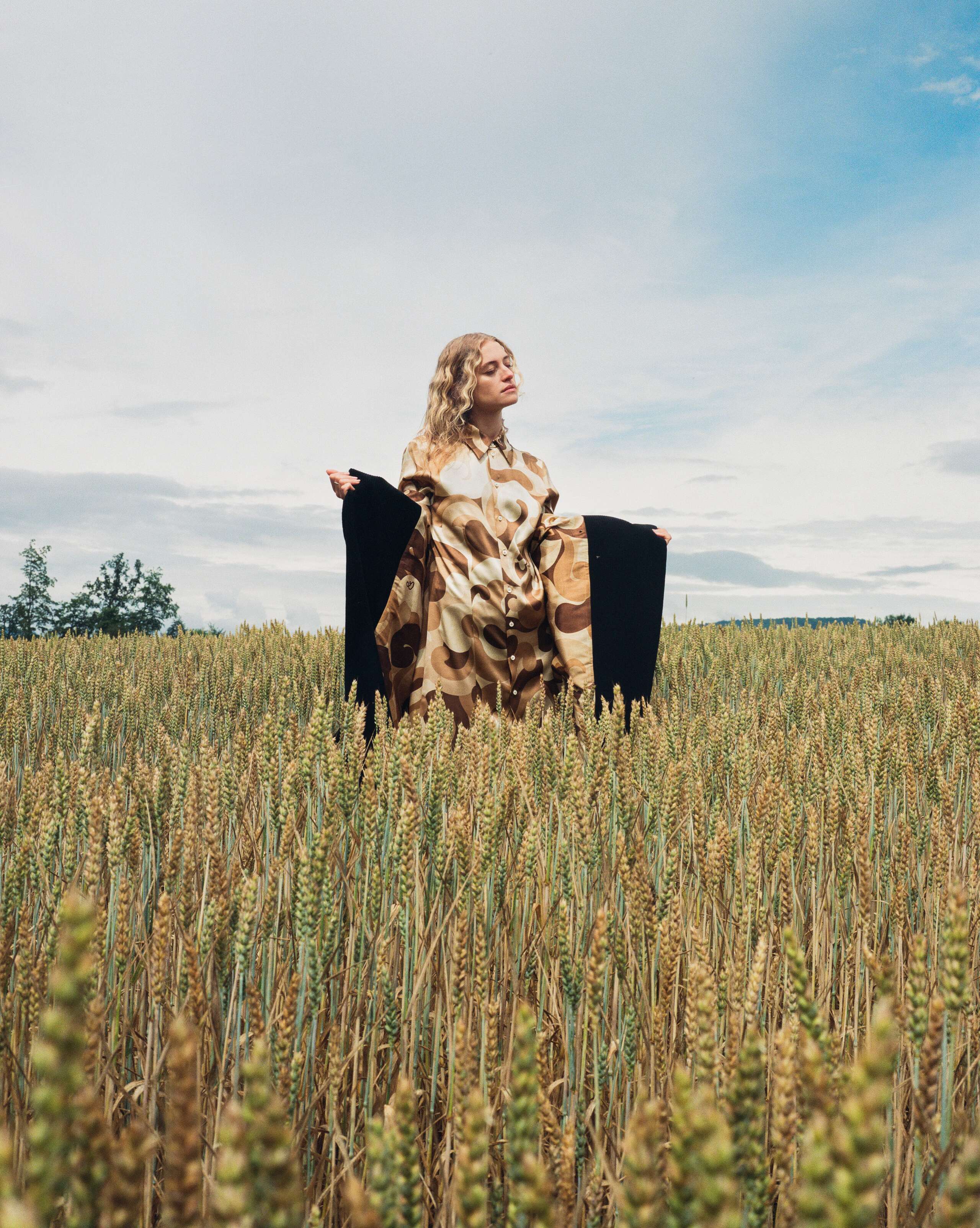 Picture of a model wearing a silk dress and a cord coat
