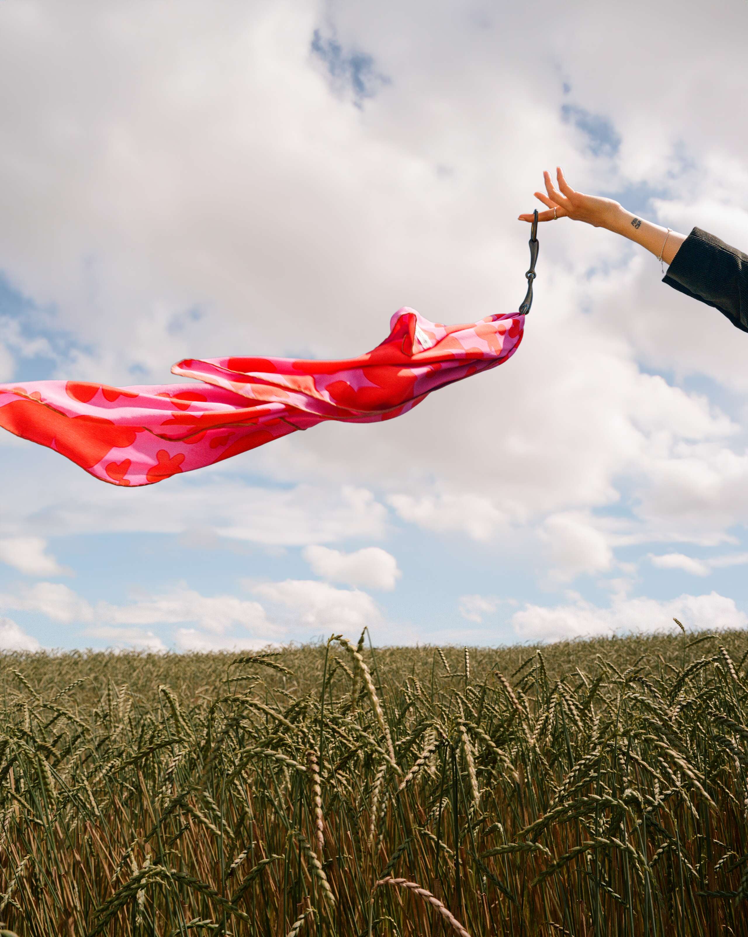 Picture of a red and pink silk foulard flying in the wind