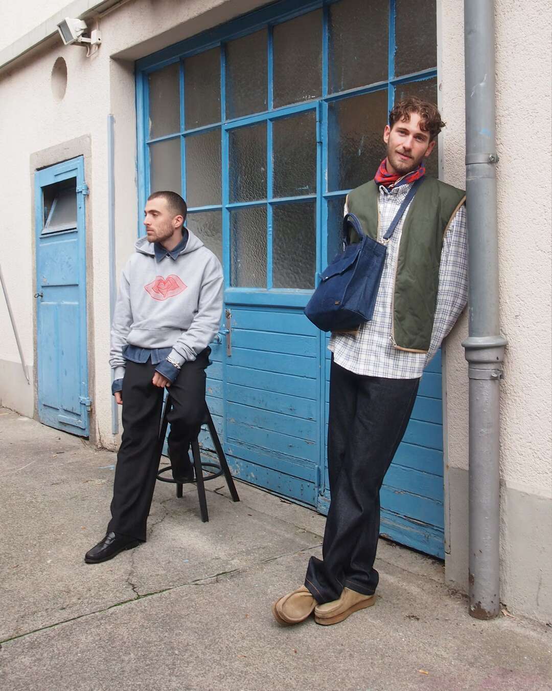 Pictur eof two men standing in front of a workshop