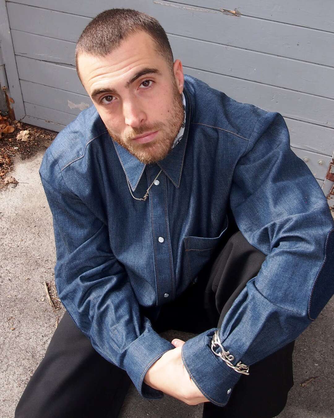 Sitting man wearing a denim shirt