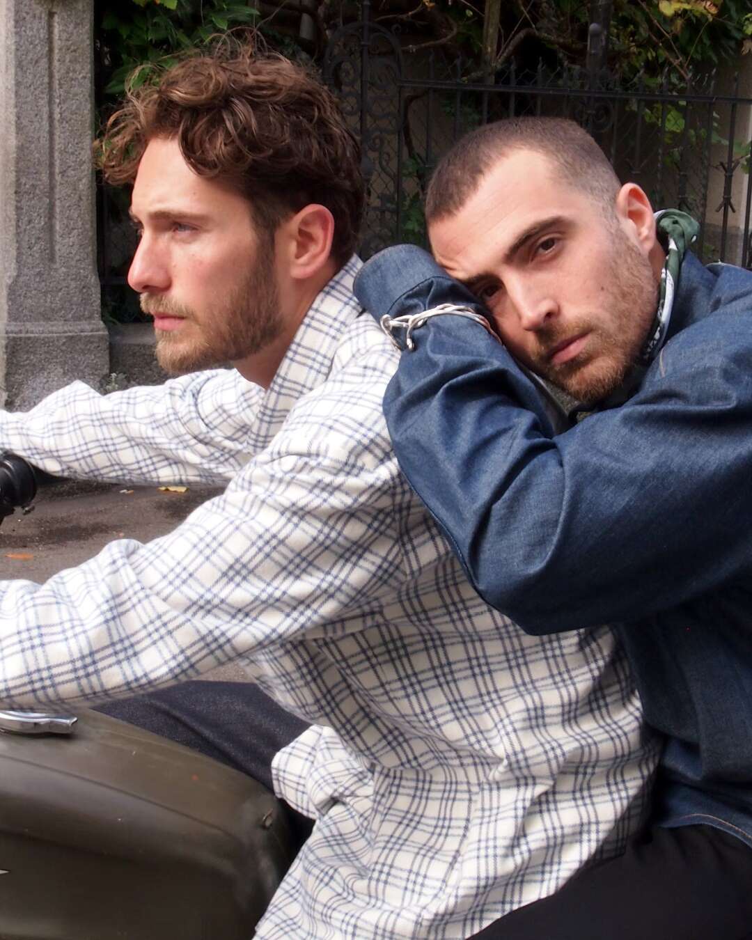 Two men sitting on a motorbike