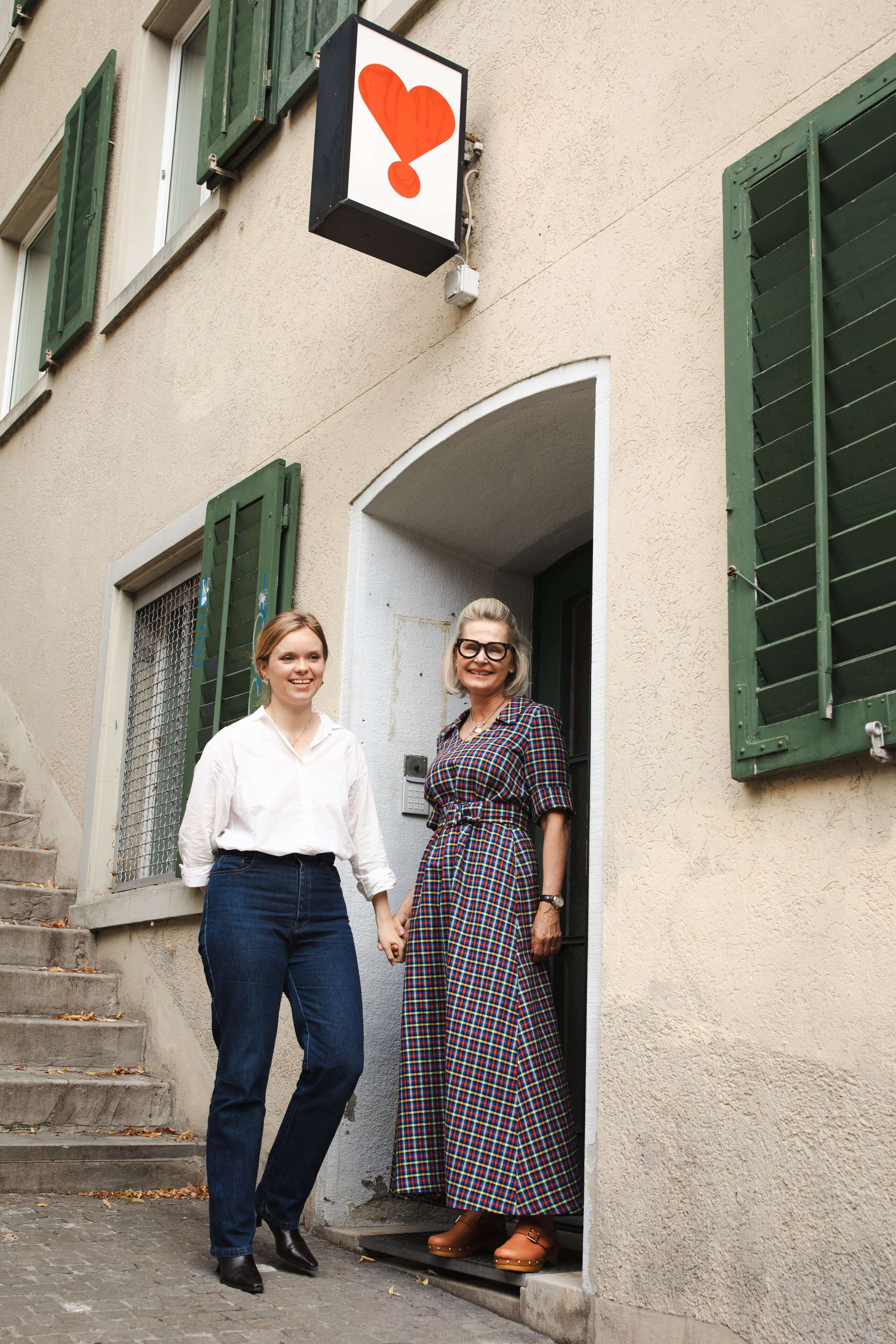 Picture of two women in front of a house