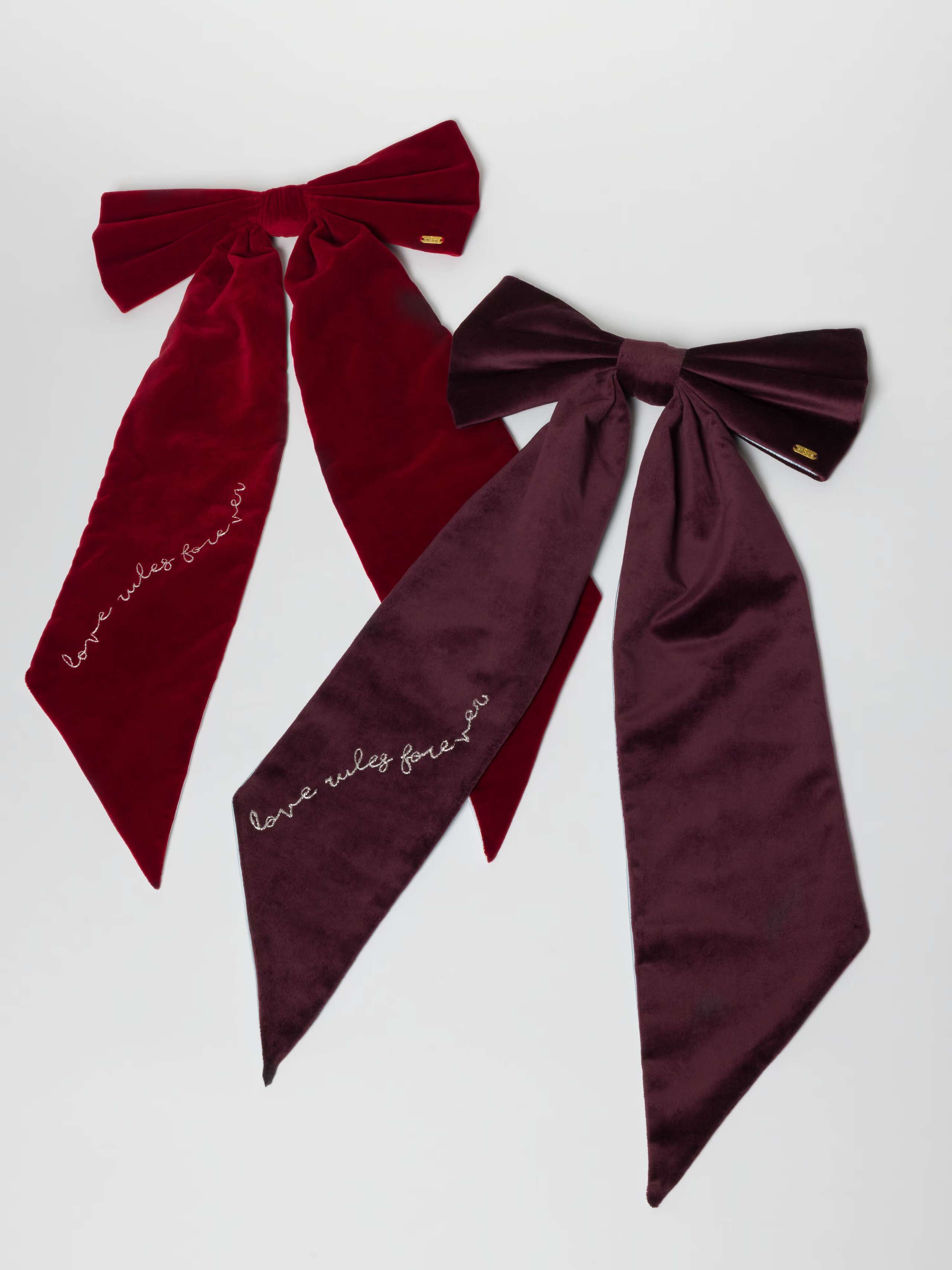 Picture of two tree topper bows made of red and purple velvet