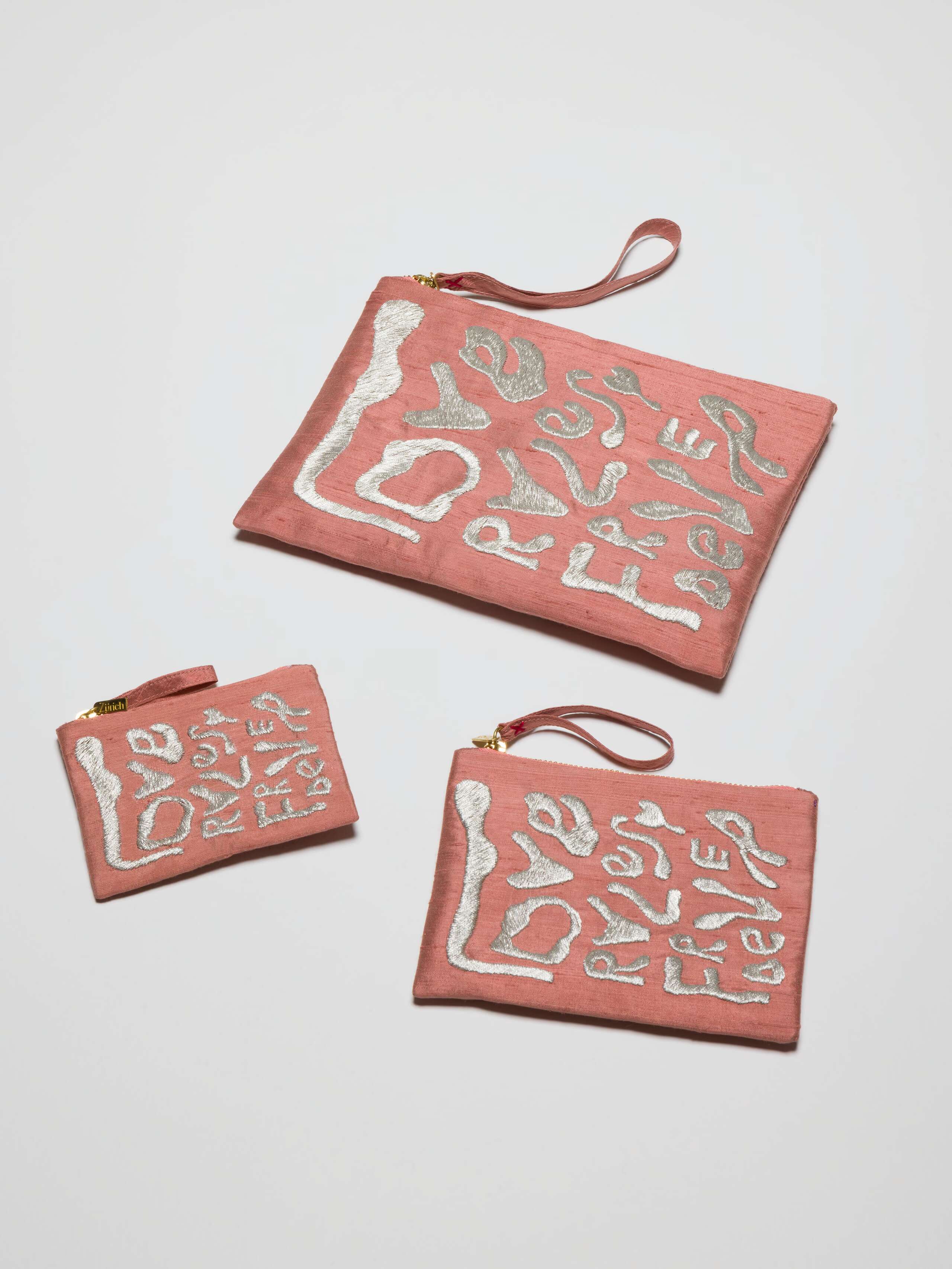 Picture of three salmon pink silk clutches