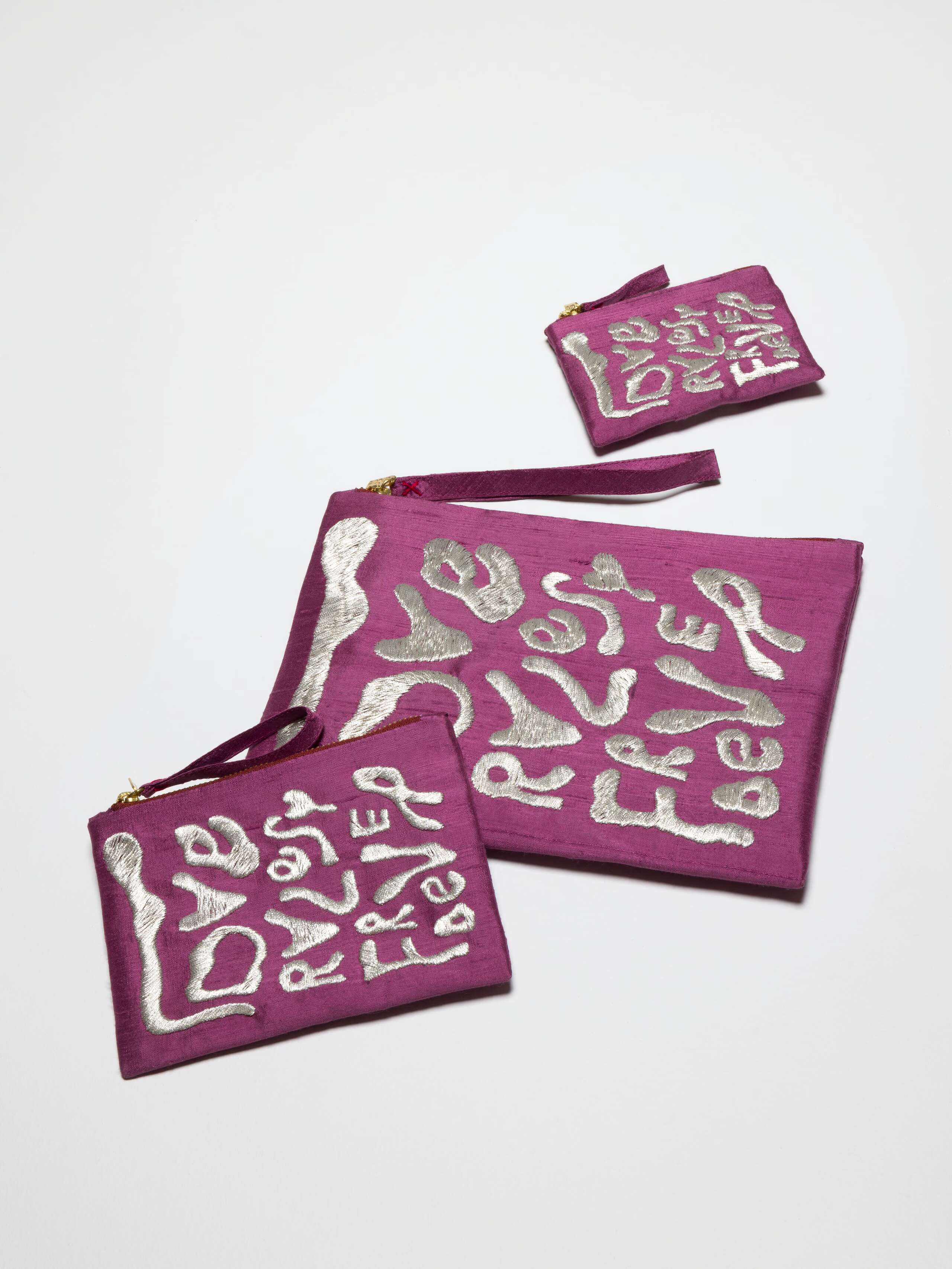 Picture of three aubergine silk clutches