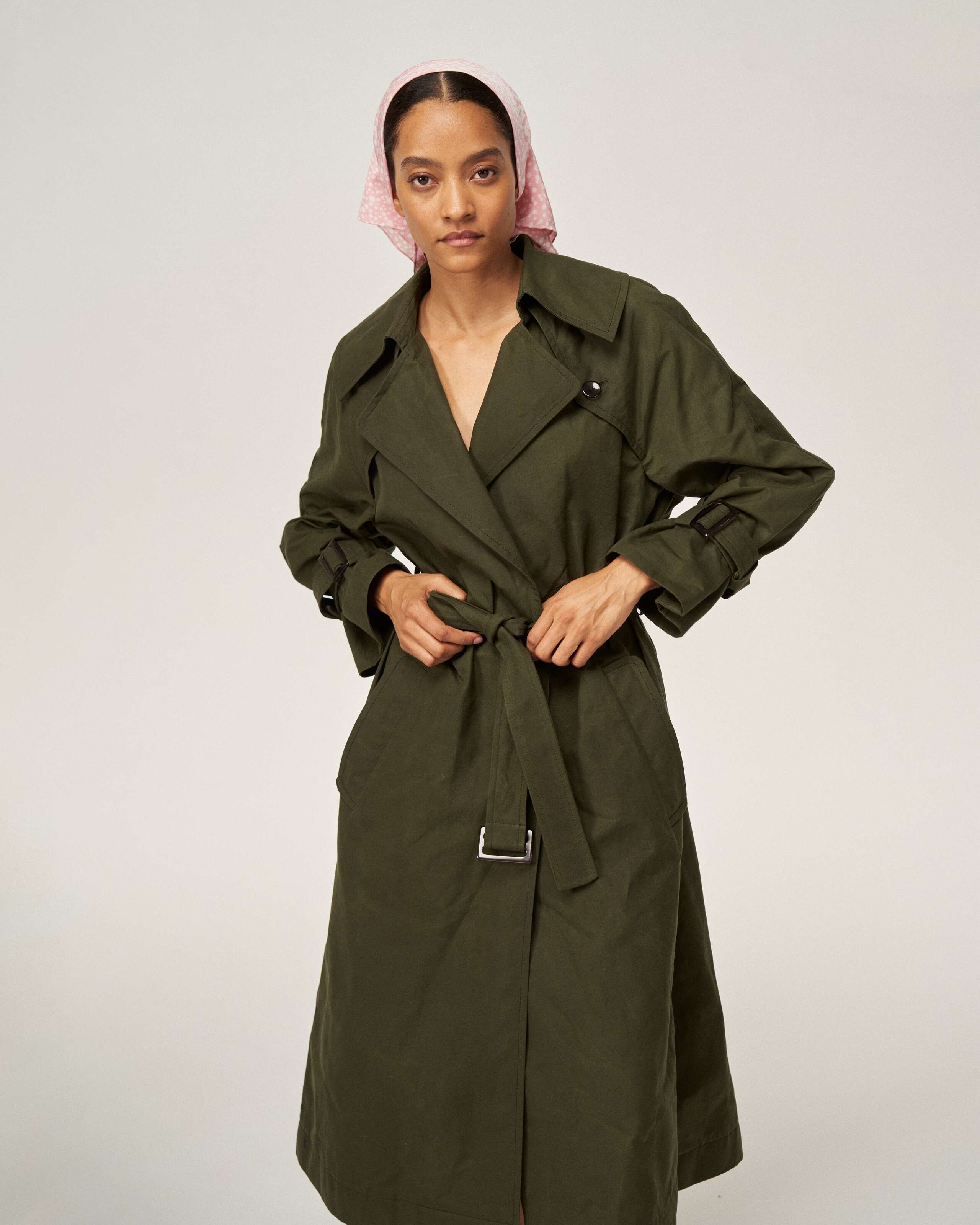 Model wearing the manhattan trench coat in khaki green