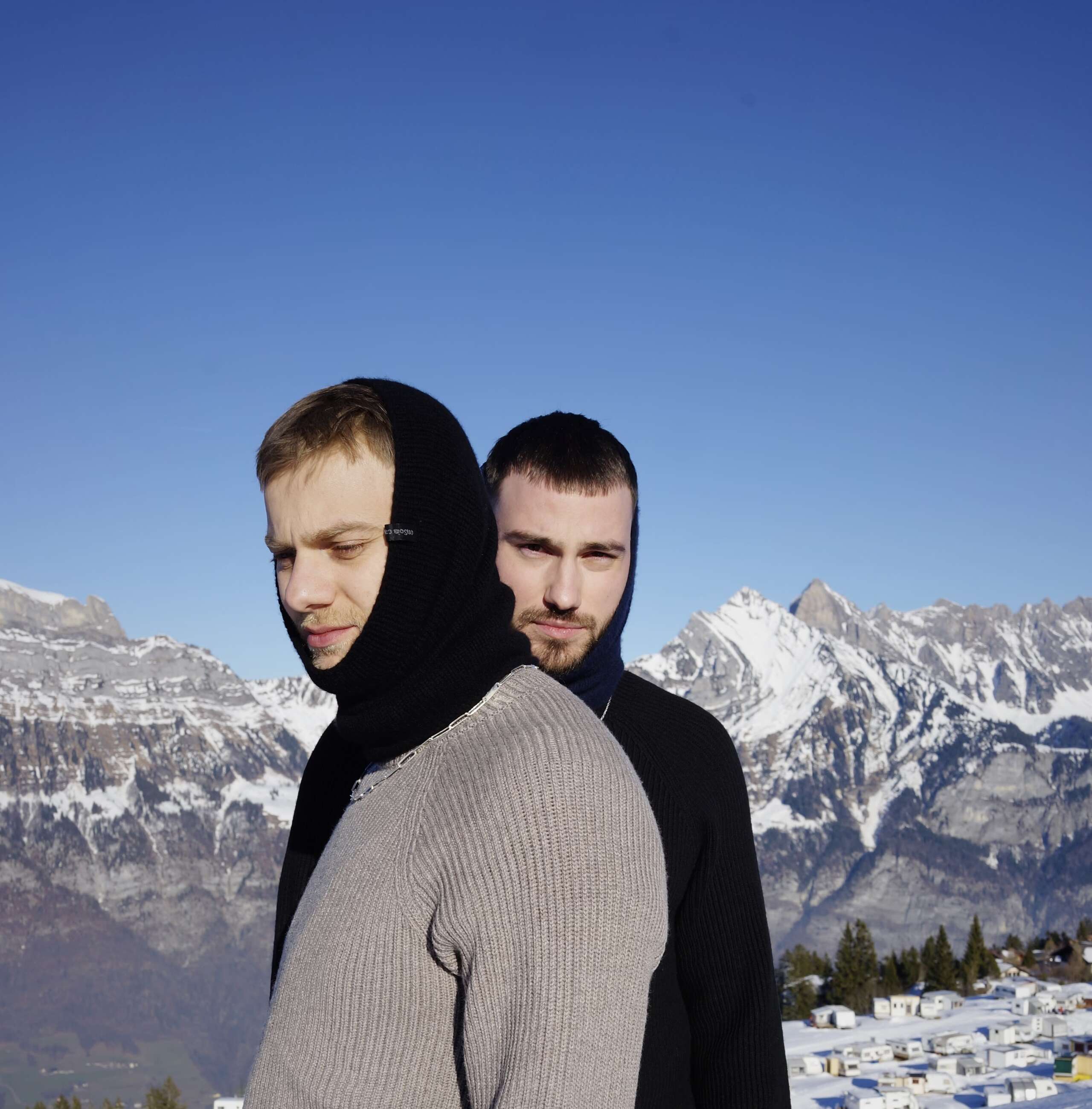 Picture of two young men standing in snow.