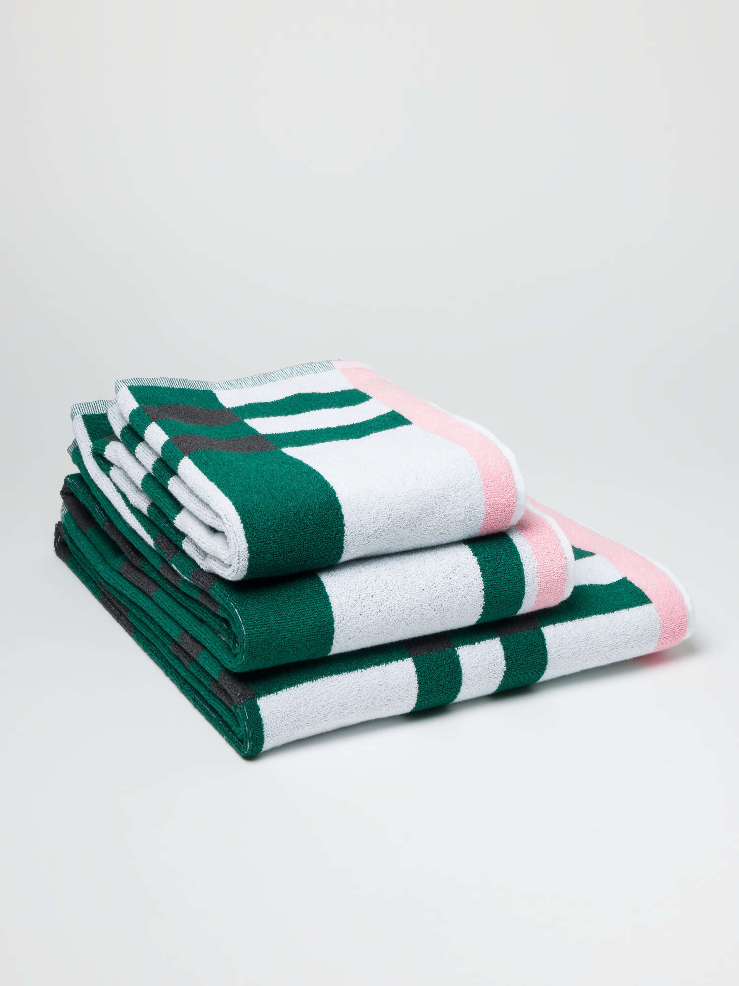 Terry bath towel in Green vichy check with pink borders in a stack