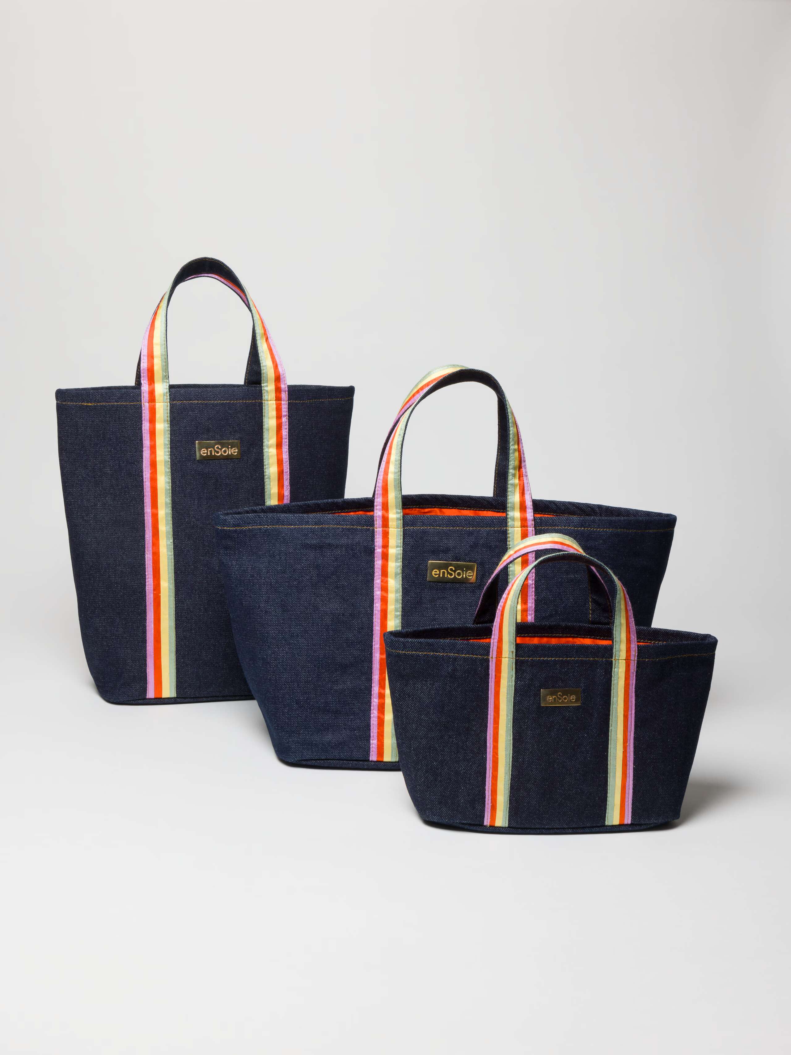 Upstate bag in denim featuring handles in three doupion silk colours combined and brasstag featuring ensoie logo in three sizes