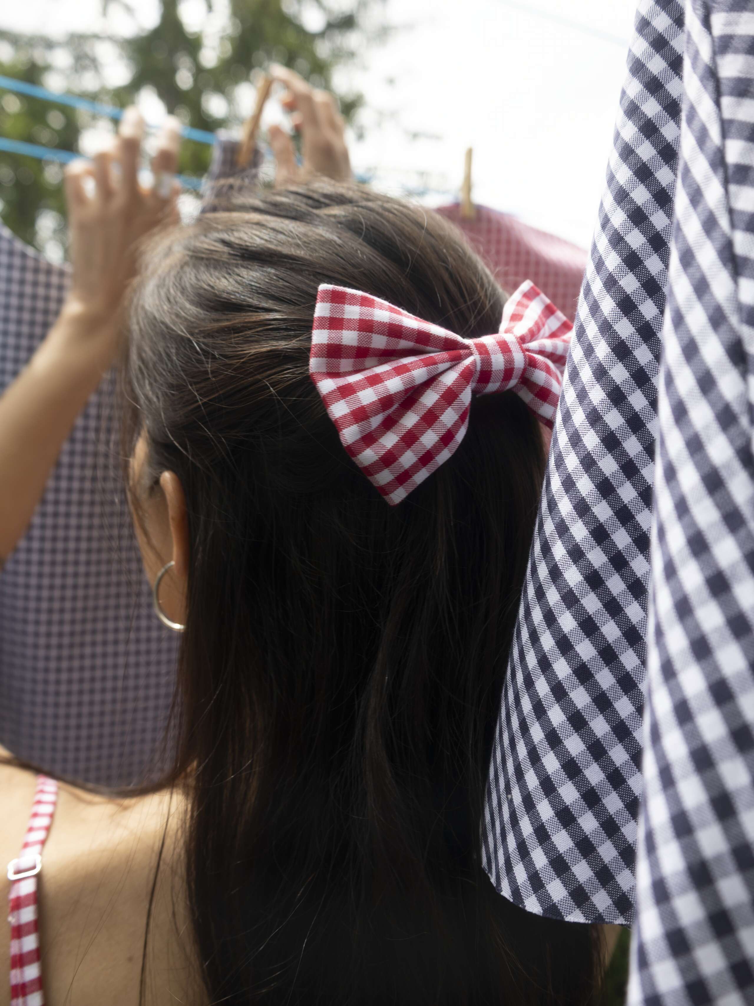 Picture of a women wearing a vichy check bow in her hair