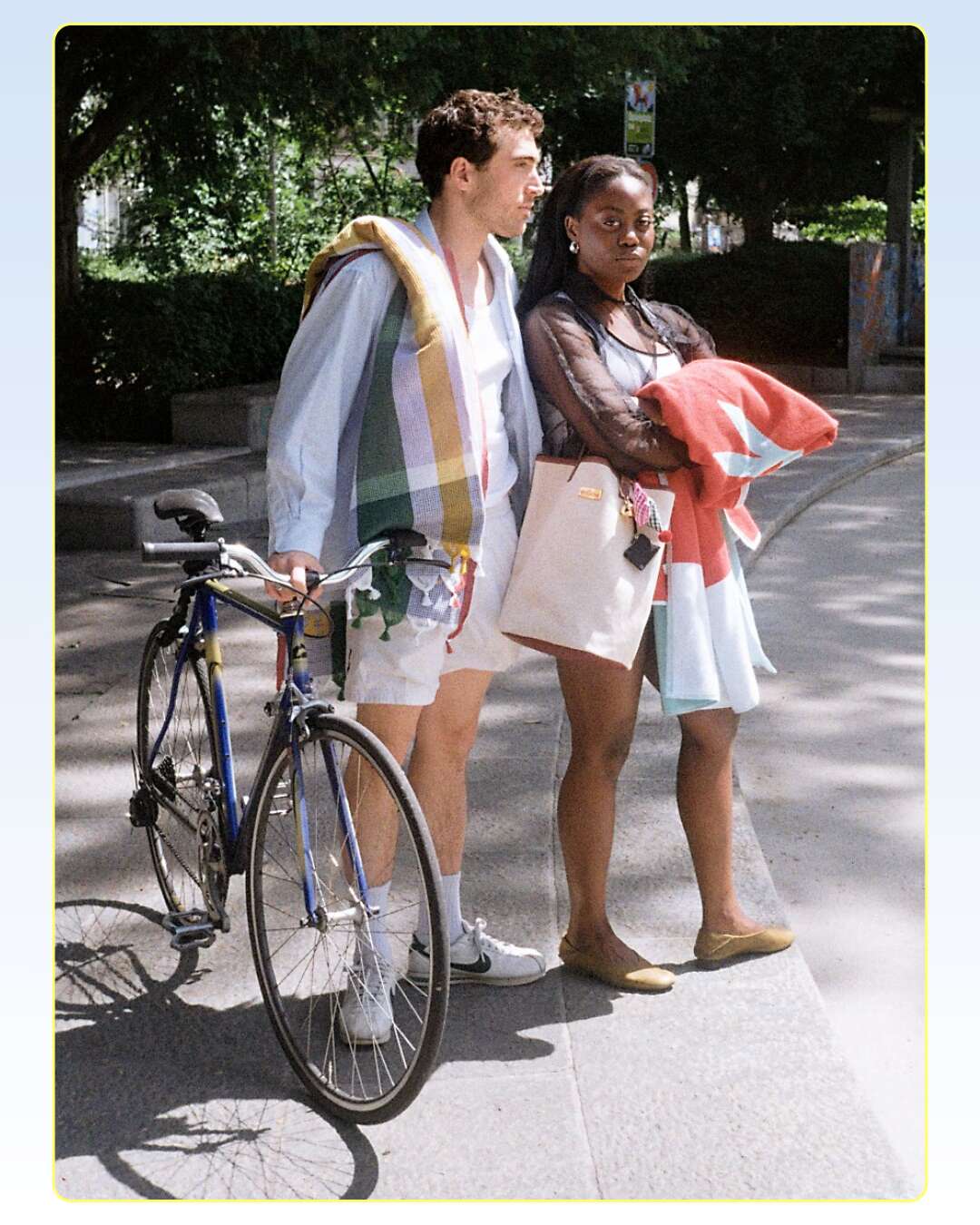 Picture of a man and a women in summery styles heading for a swim