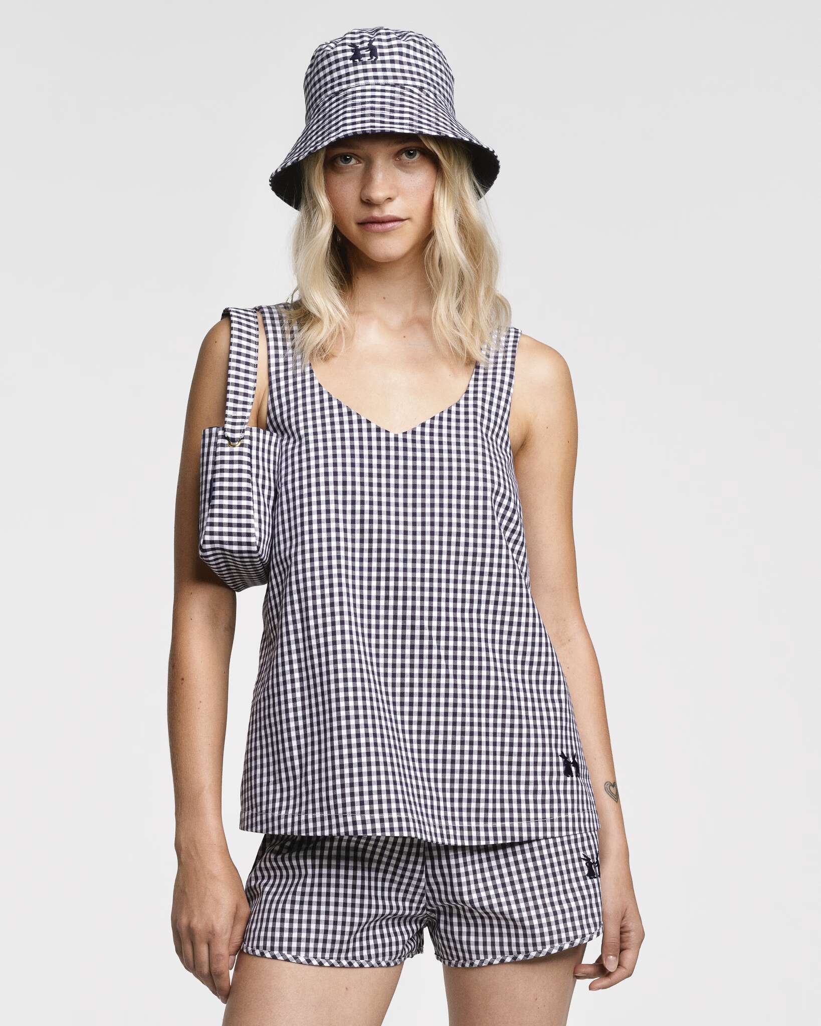 Model wearing the sleeveless Tia top in Navy vichy check and matching Dionne shorts