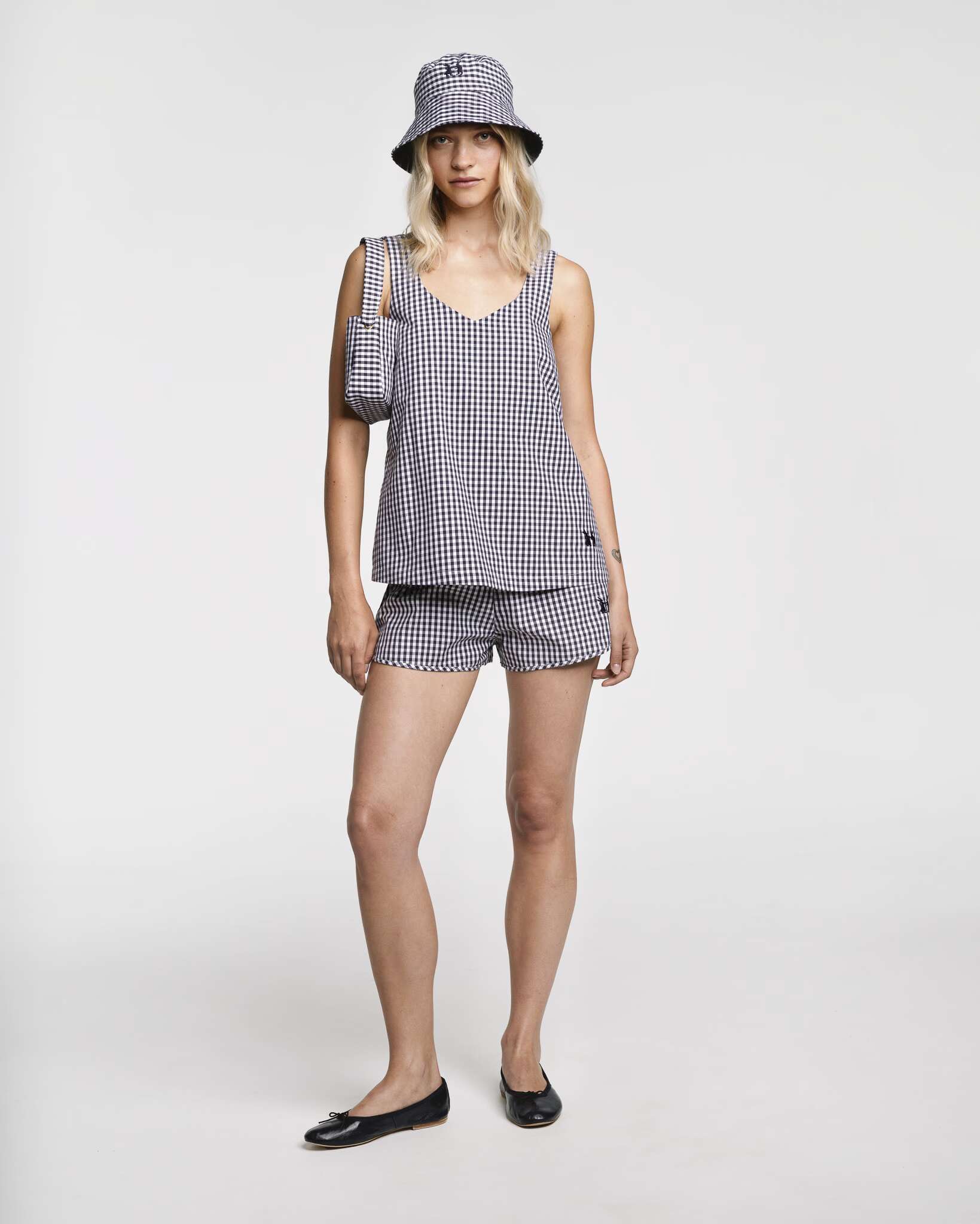 Model wearing the sleeveless Tia top in Navy vichy check and matching Dionne shorts