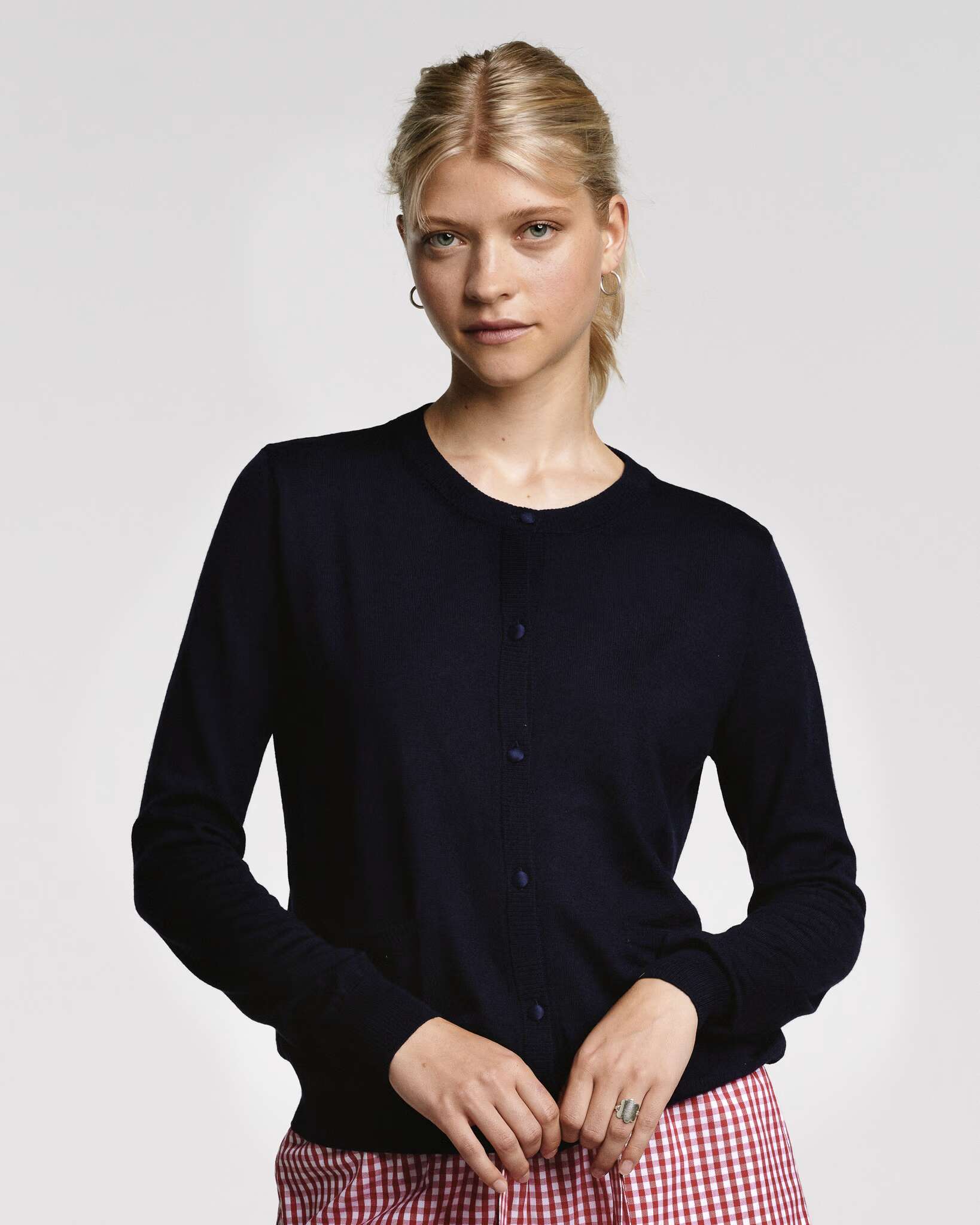 Model wearing Navy wool cardigan with silk buttons