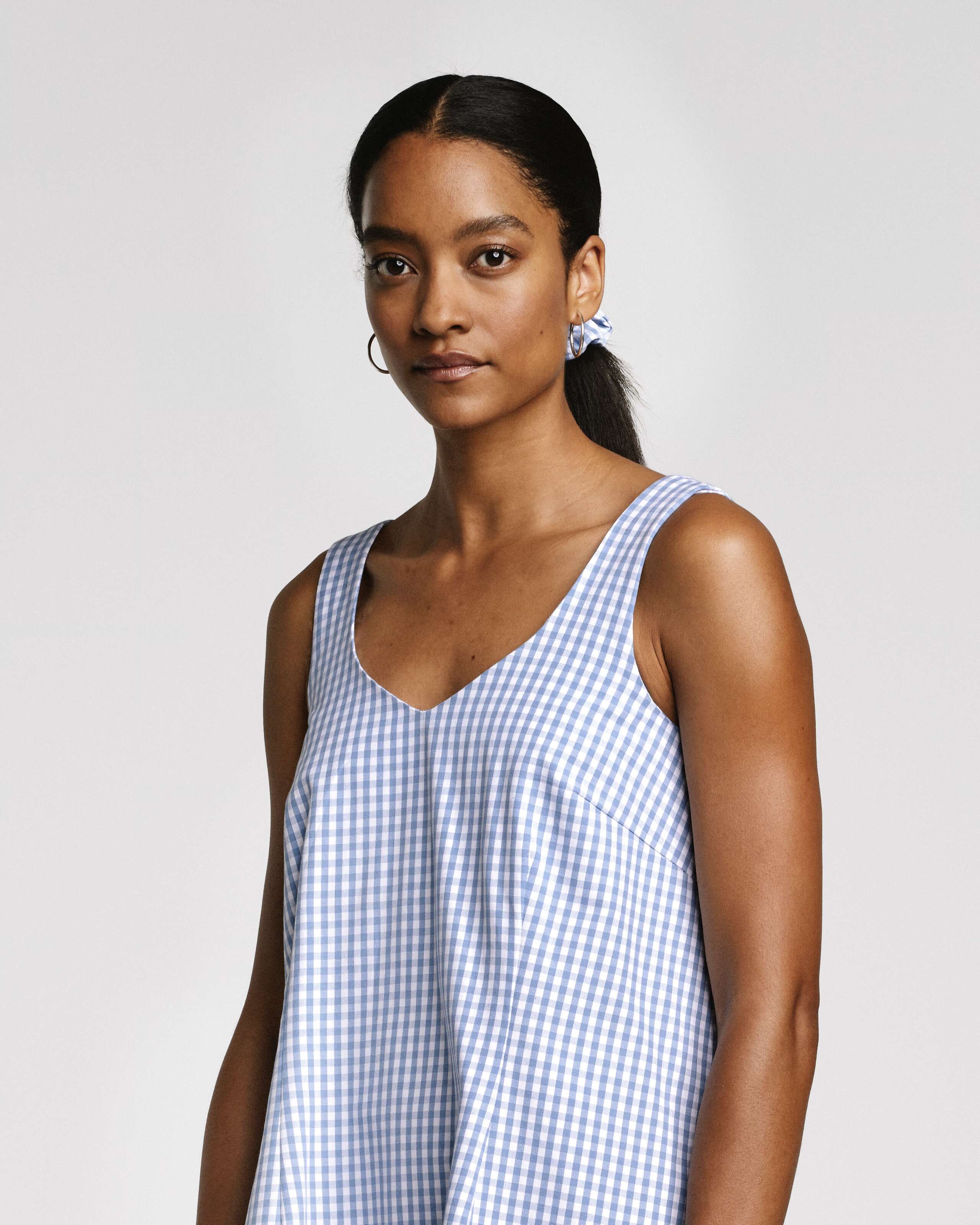 Model wearing the Tia top in light blue vichy