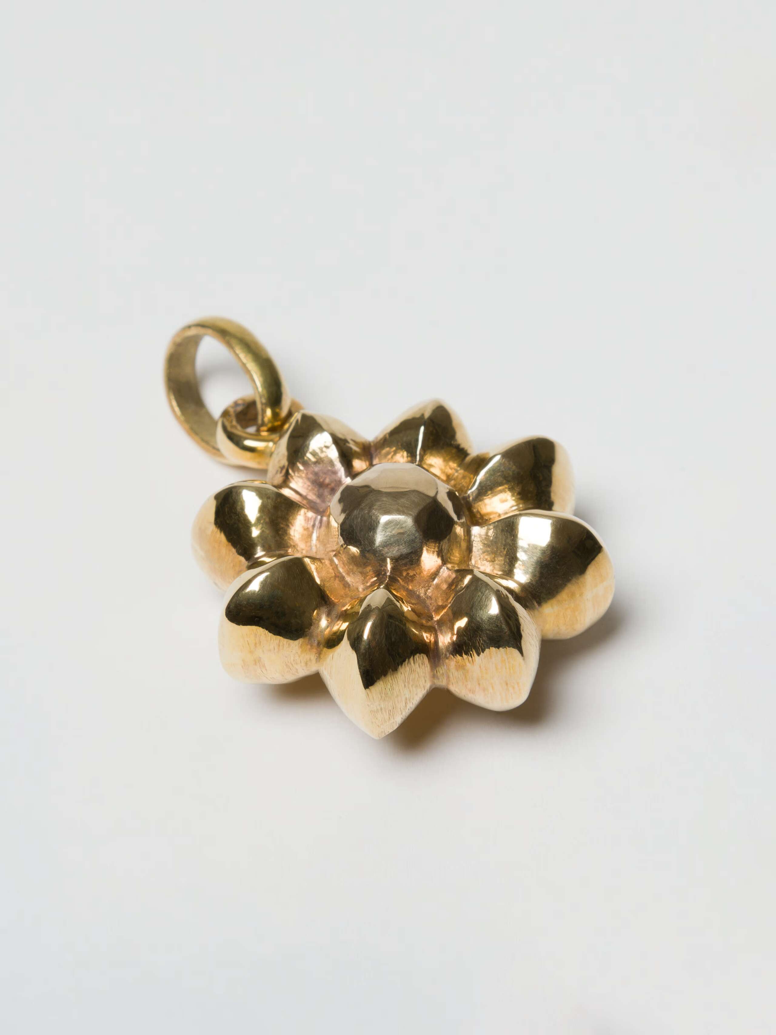 Fancy rosette charm in brass