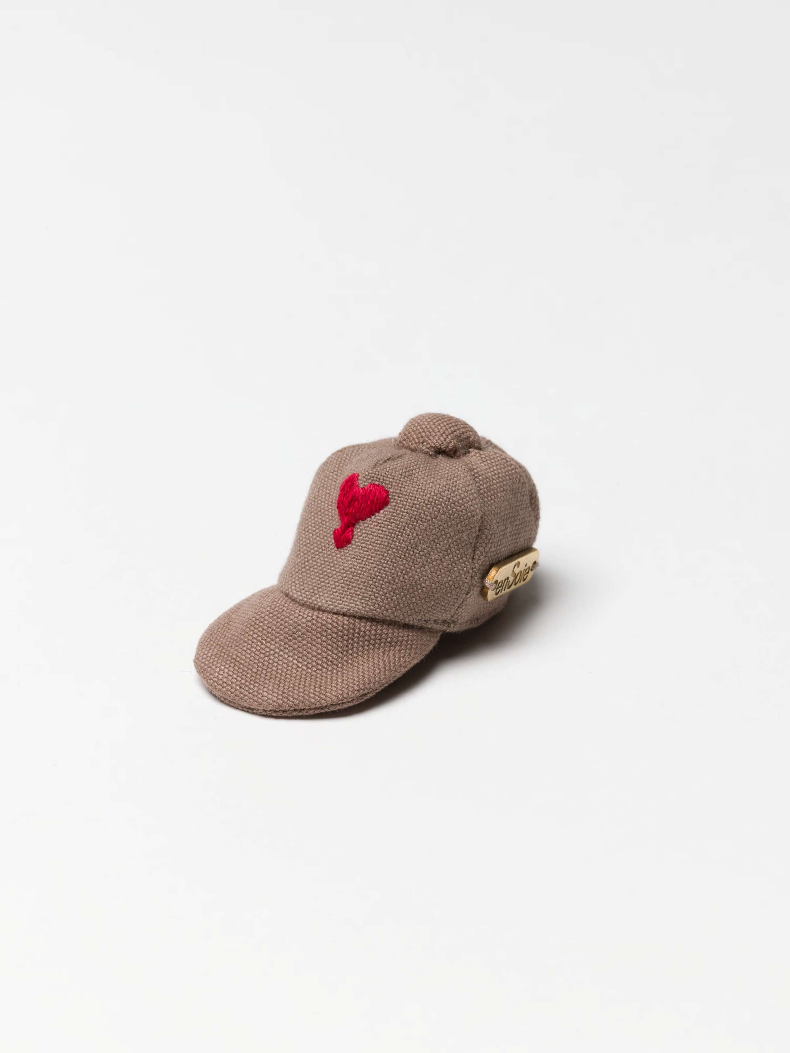 Fancy Tommy Cap charm in moon rock with red heart