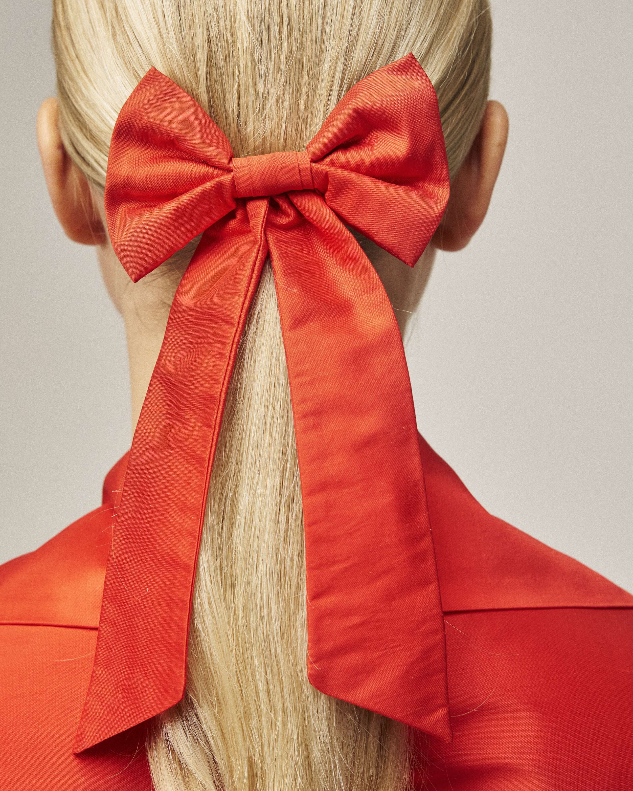 Picture of a women wearing a red silk bow in her hair