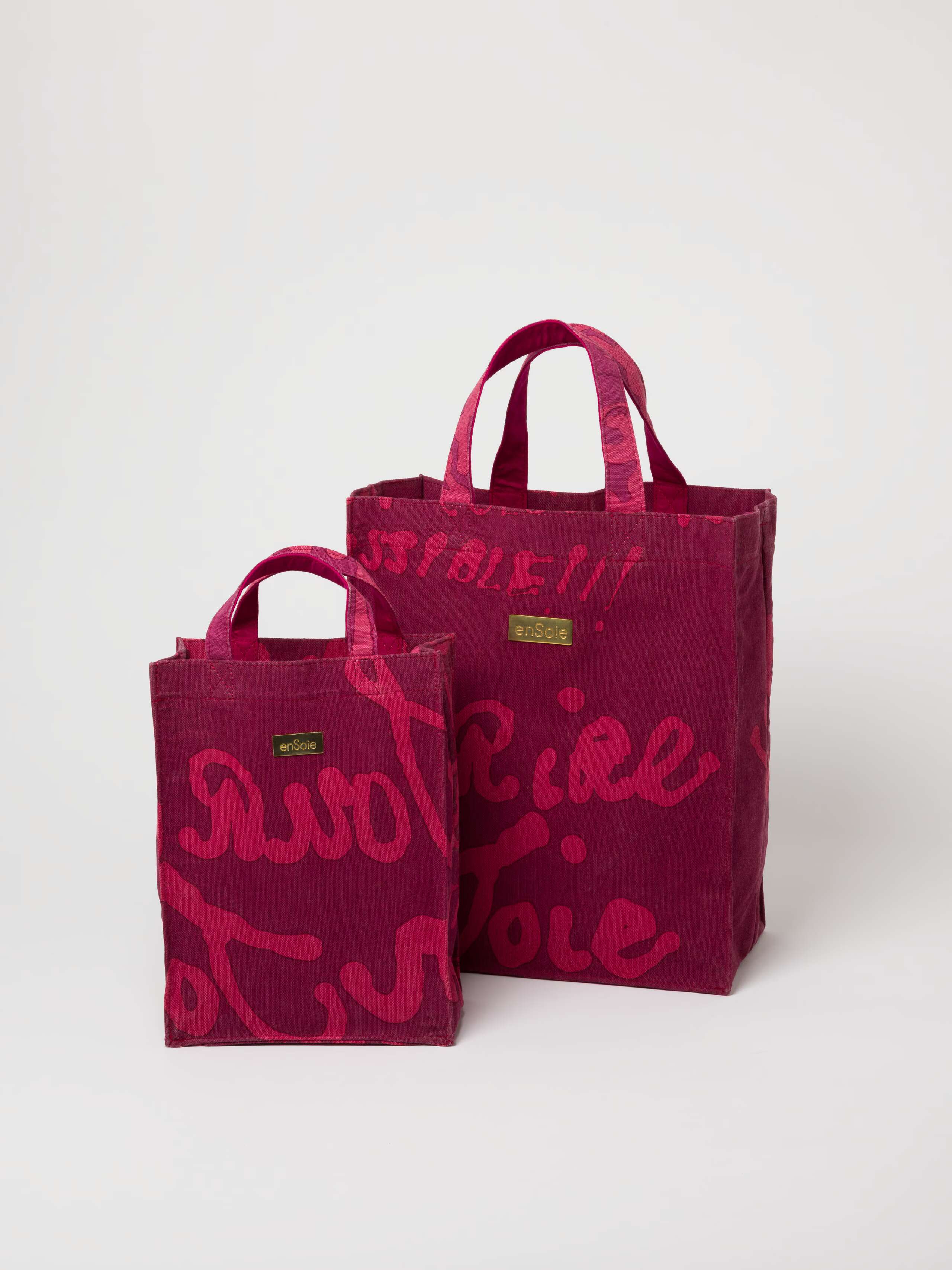 Picture of two canvas bags in burgundy and pink shades