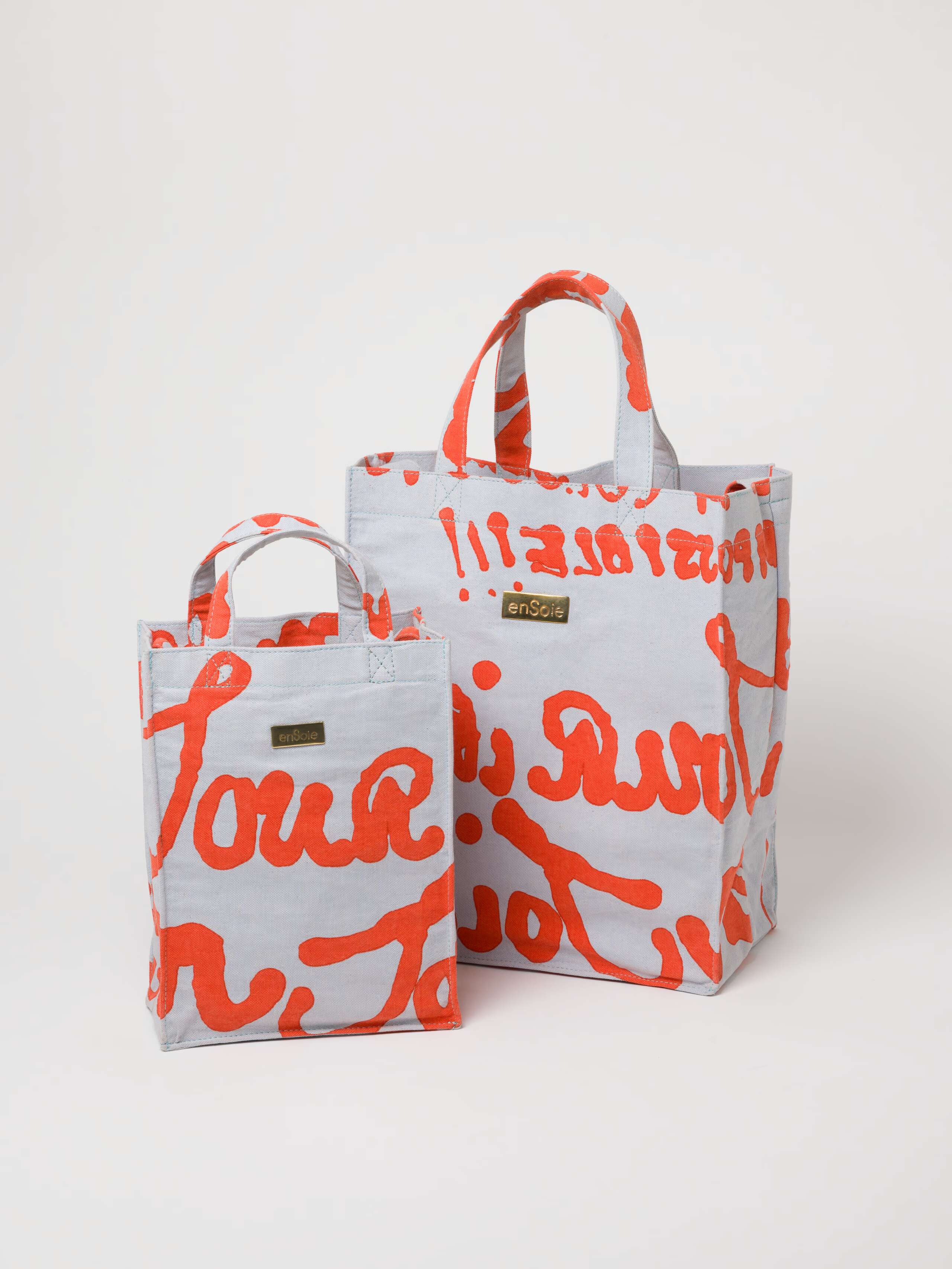 Picture of two canvas bags in light blue and rust shades