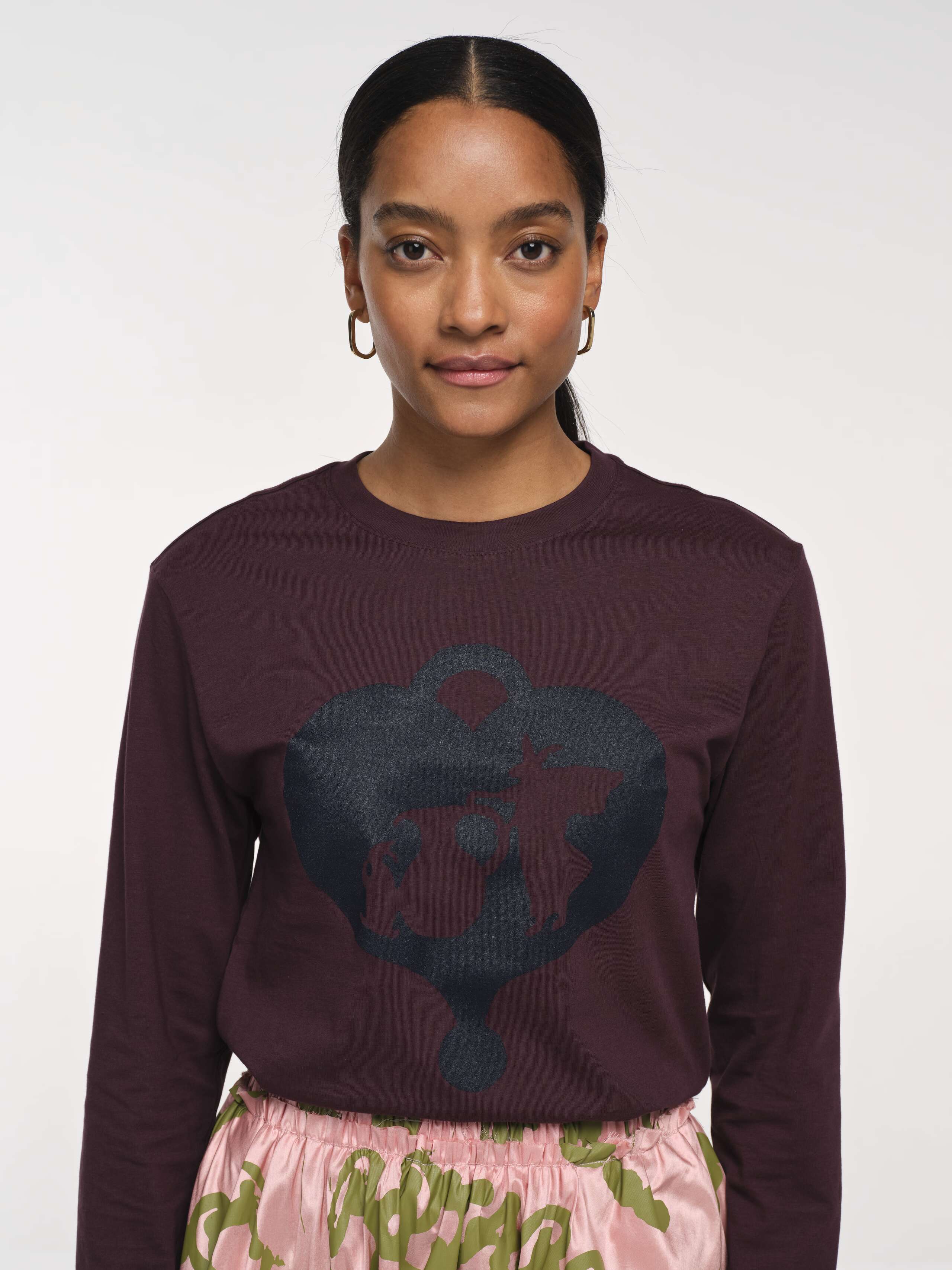 Detail Front Shot of Model Wearing Brown APOH Longsleeve with Black Printed Classic Logo Bunny Pot Logo  
