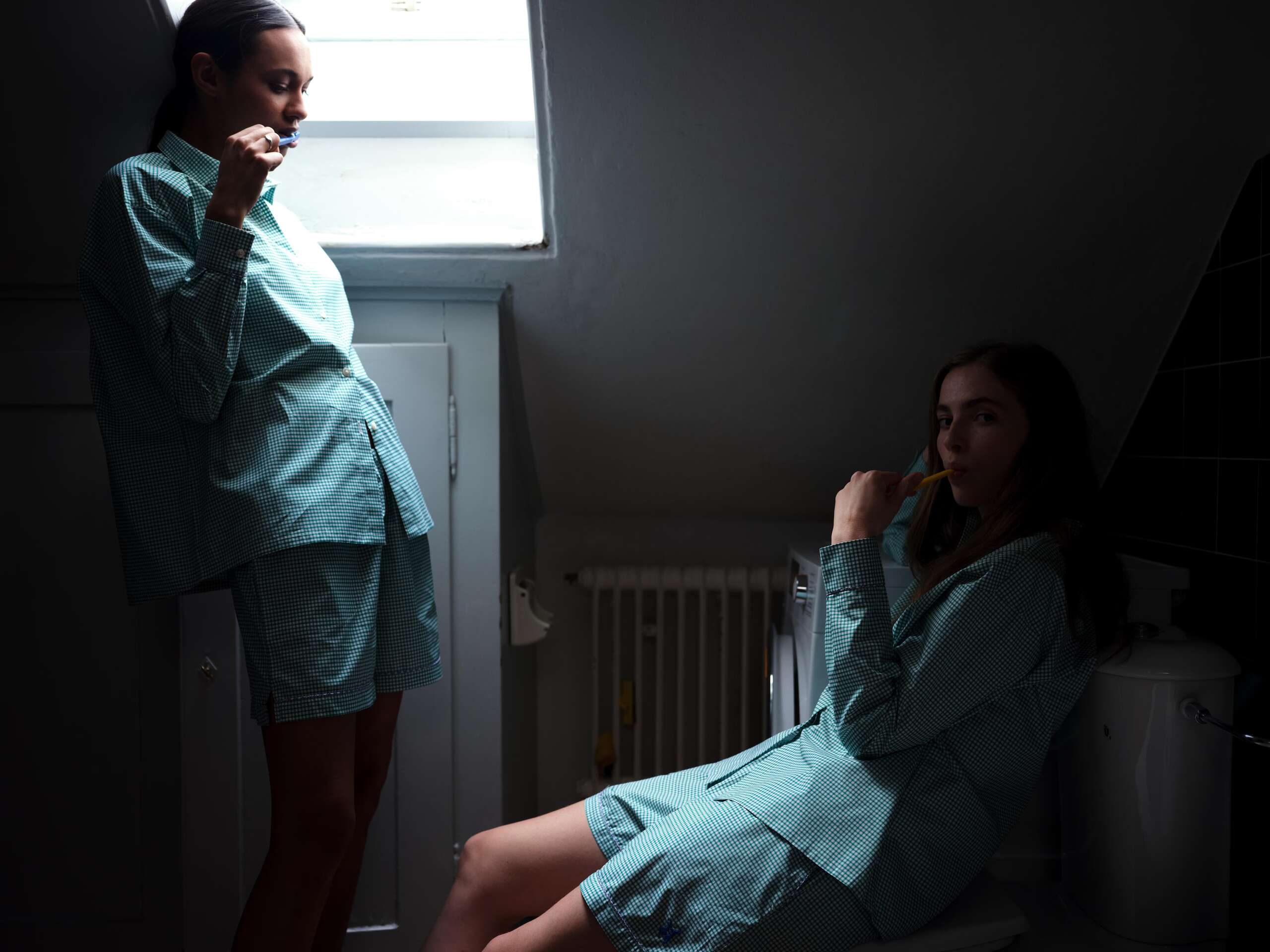Two women brushing teeths