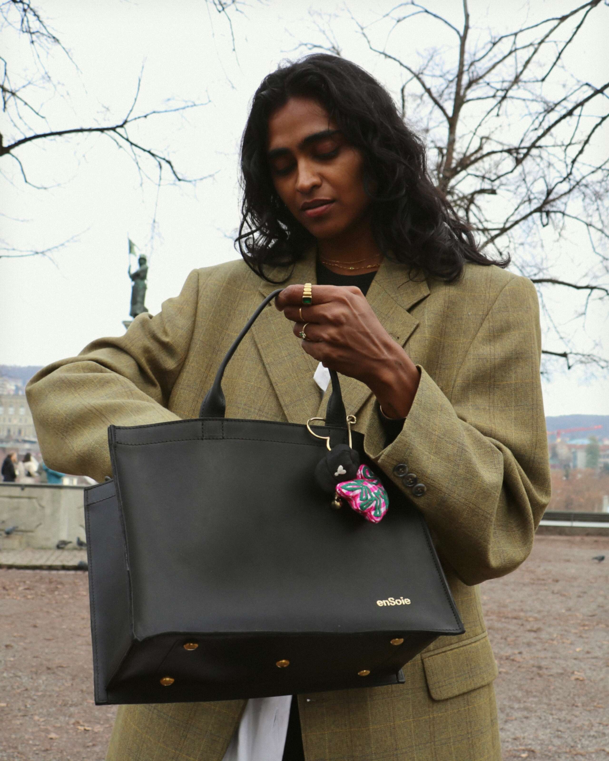 Picture of a young women, wearing a light beige jacket 