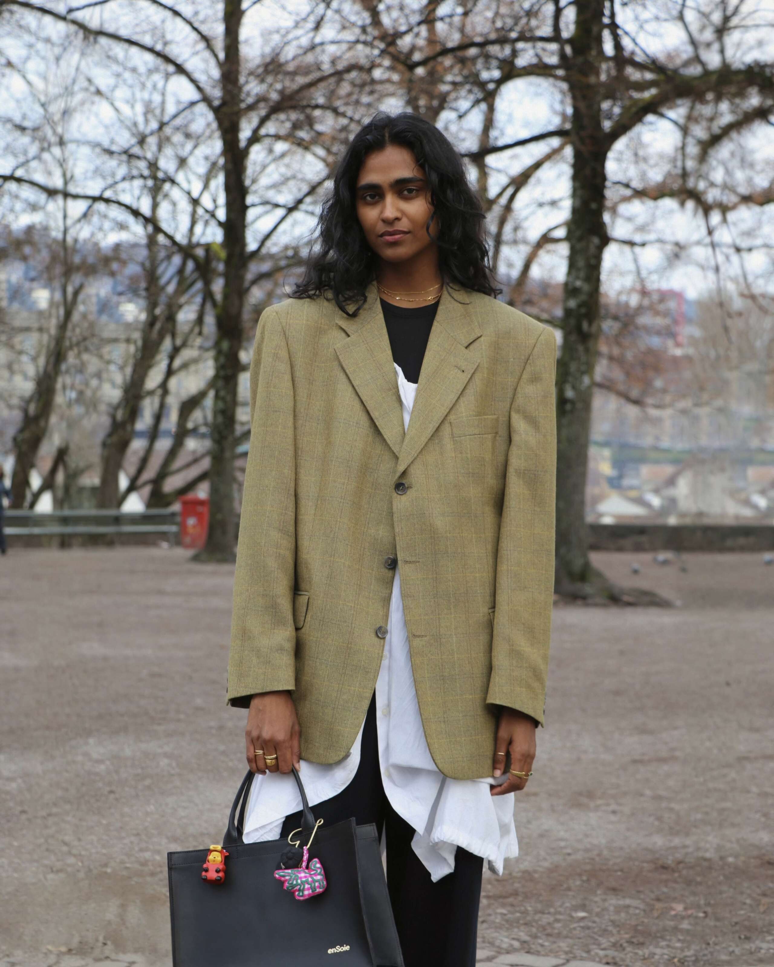 Picture of a young women, wearing a light beige coat