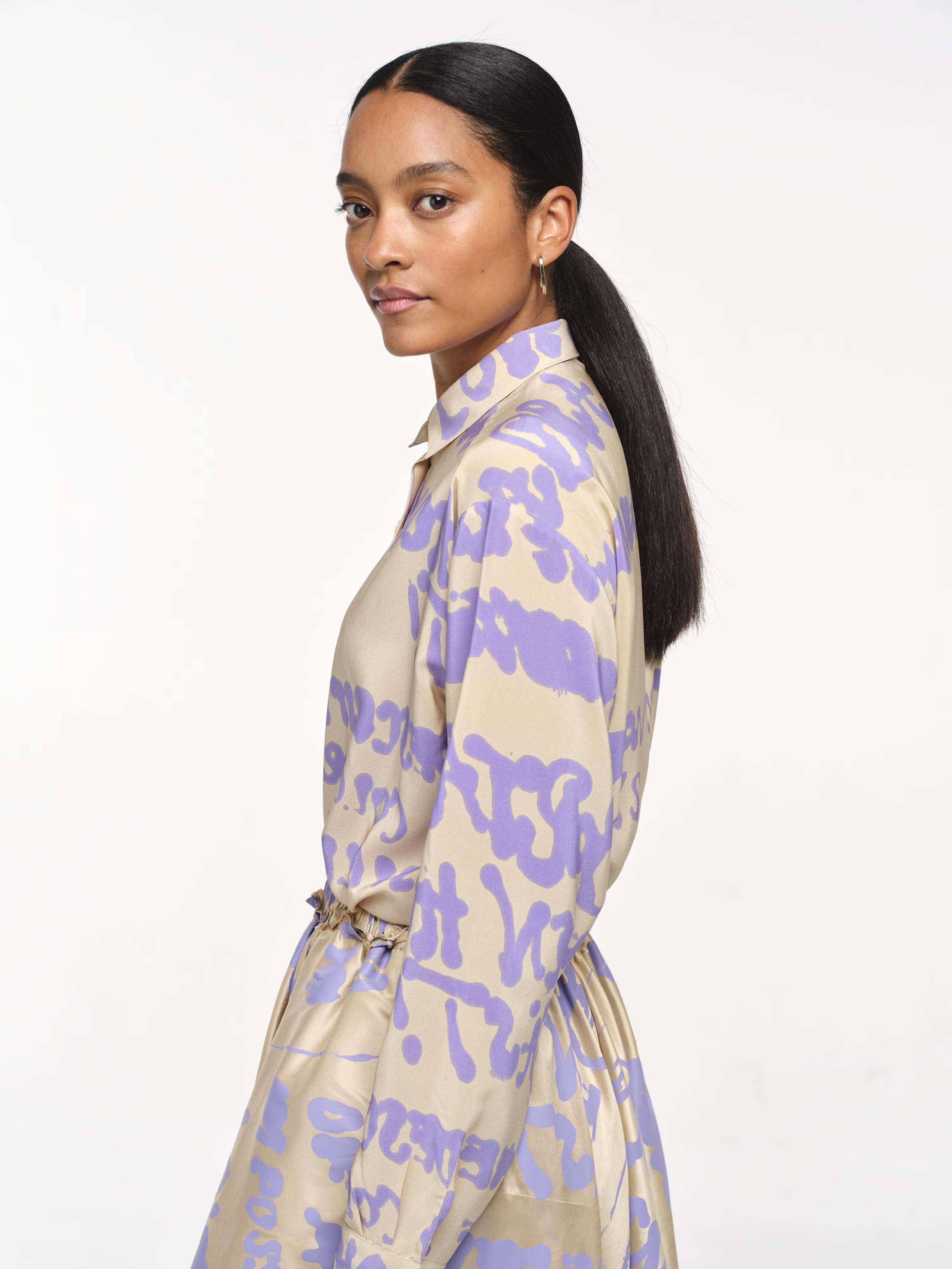 Picture of a women wearing a light beige blouse