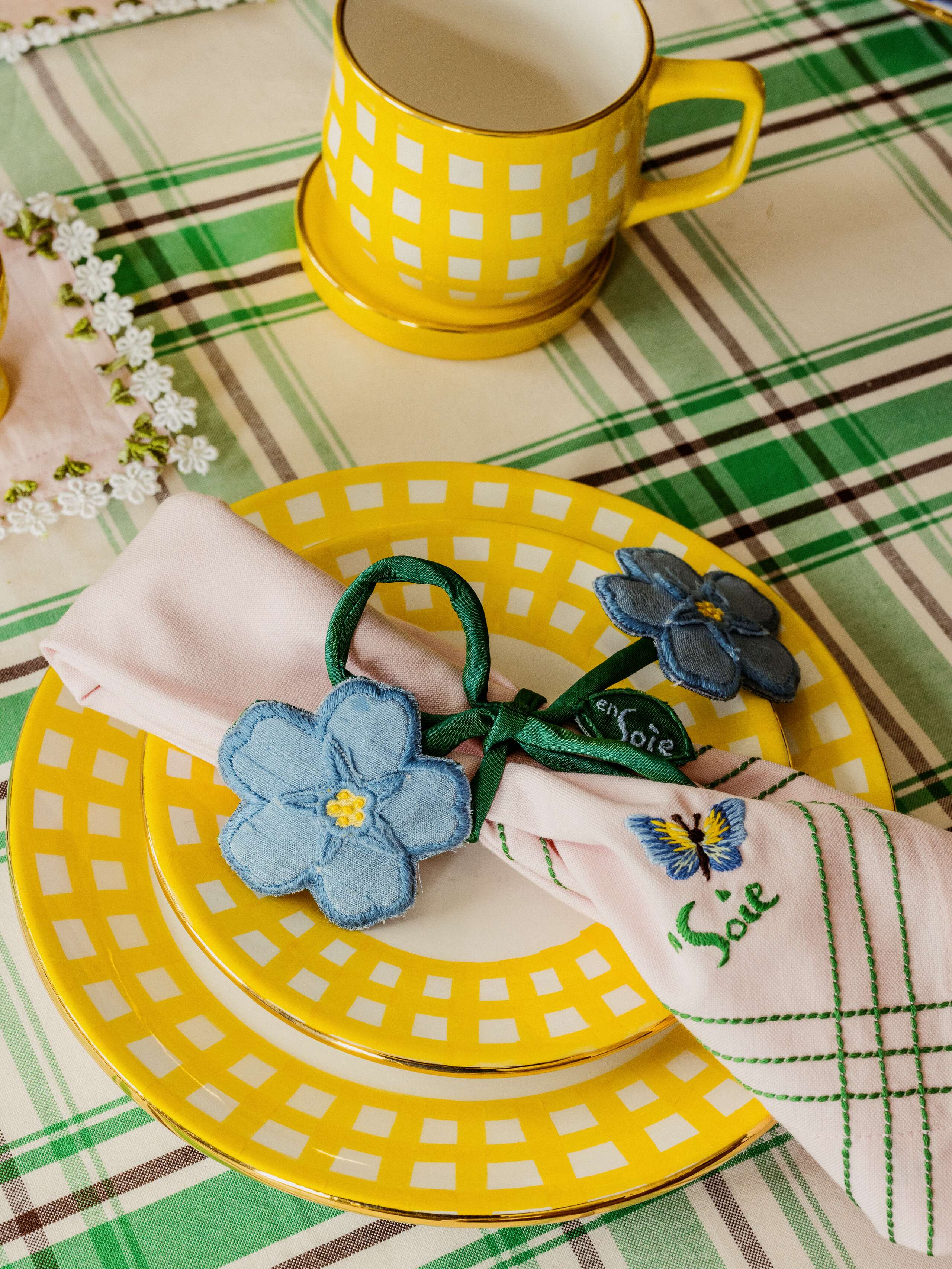 Picture of two plates and a cup featuring a yellow gingham rim