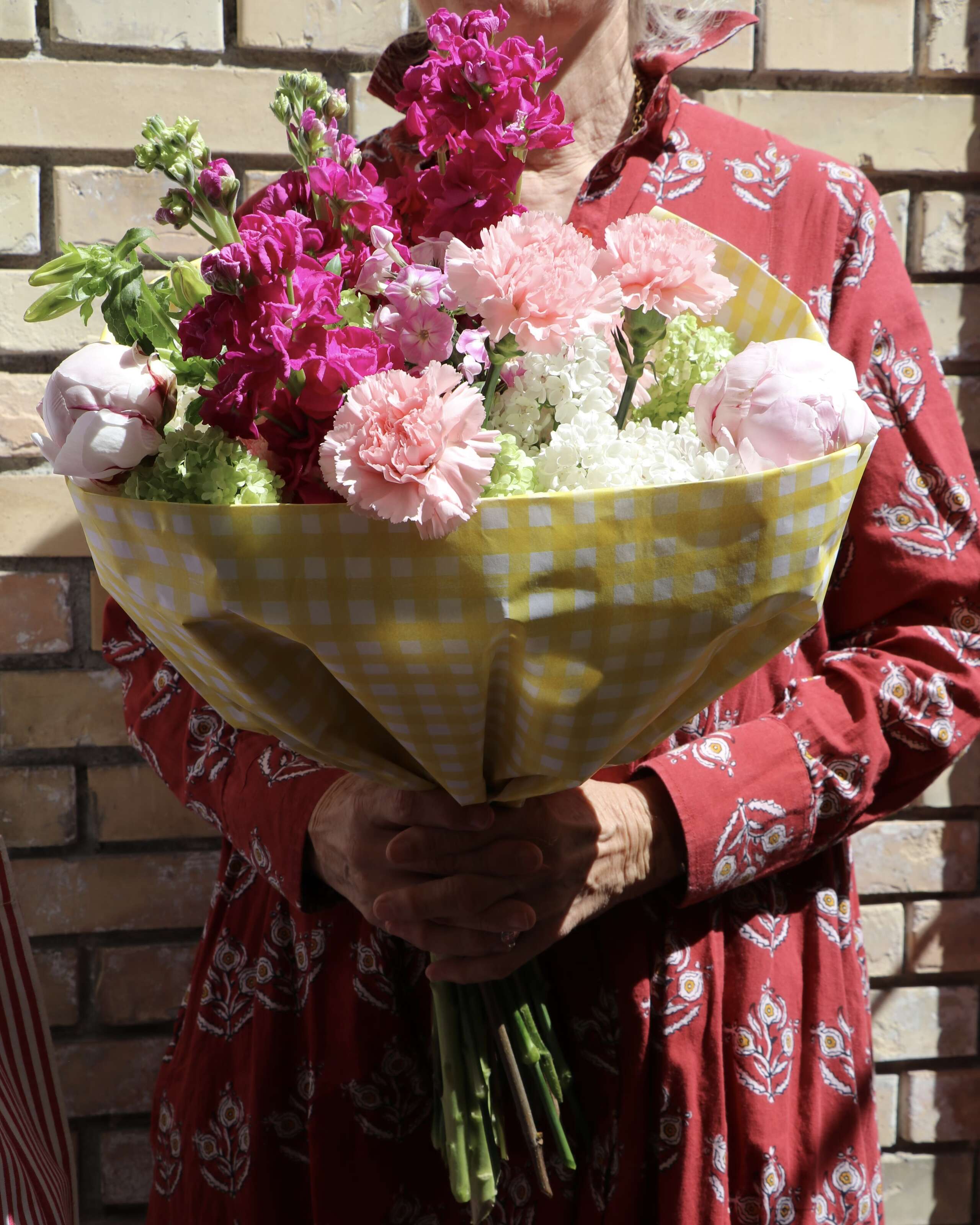 Picture of a women holding a big flower bouquet