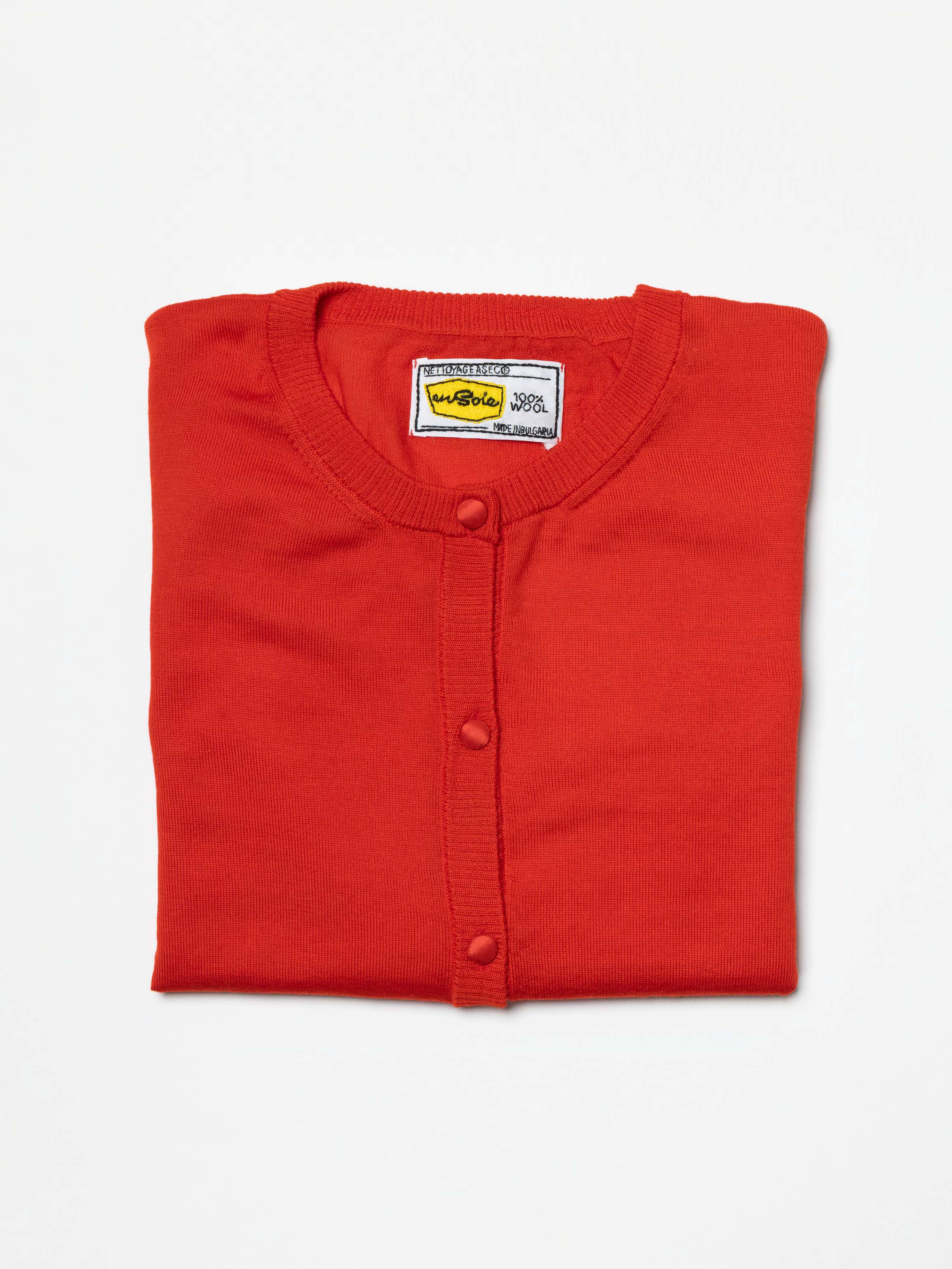 Product Shot of folded Bea cardigan in Warmest Red 