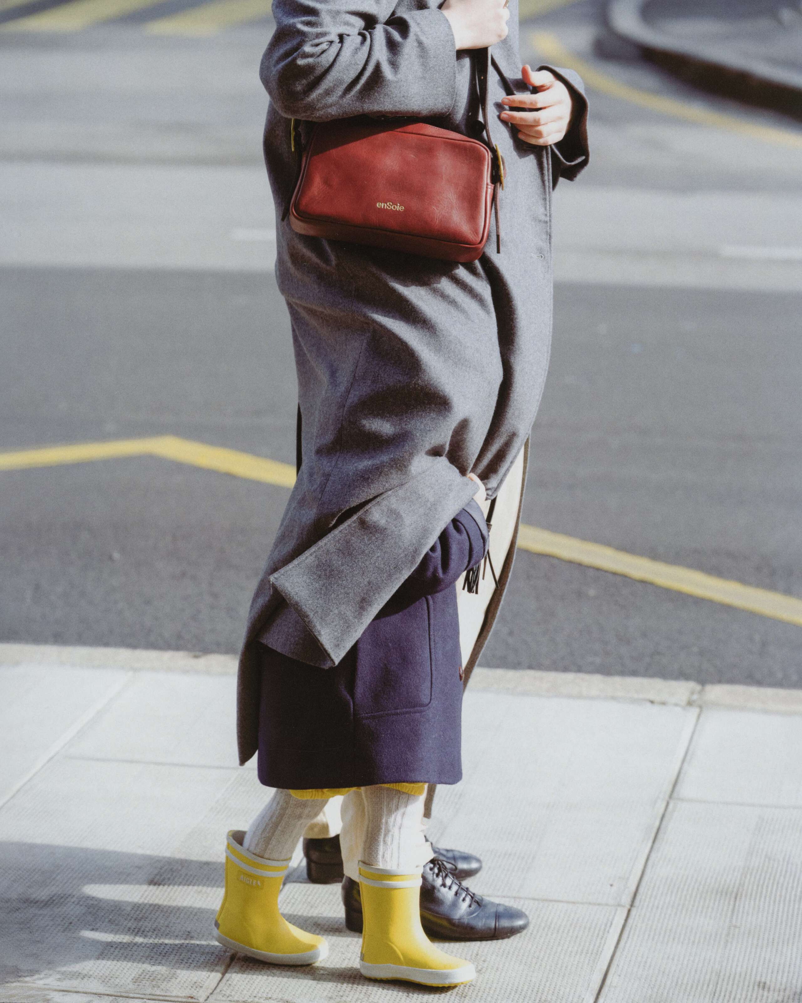 Picture of a women carrying a small red enSoie leather bag