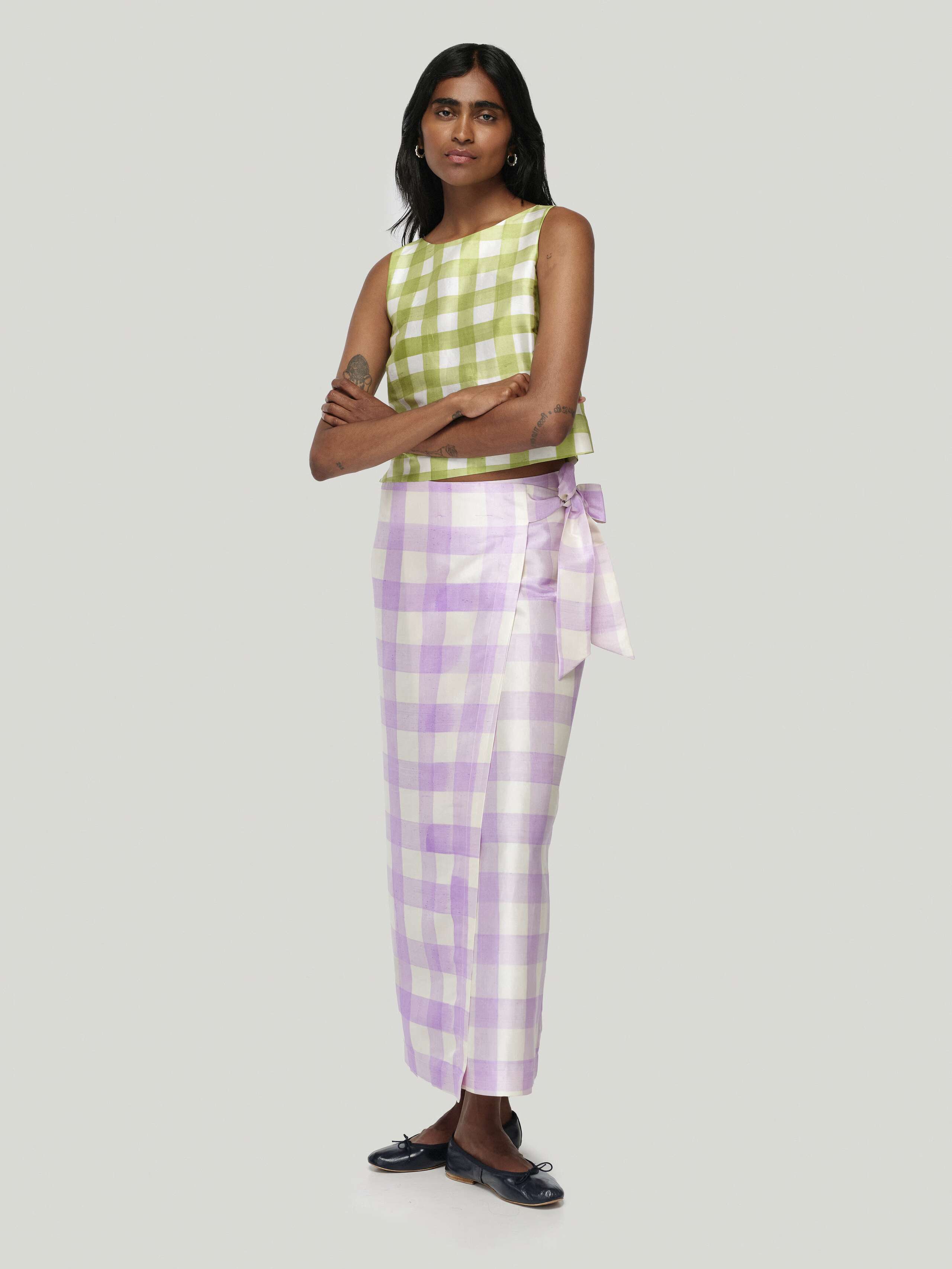 Model wearing edina long skirt handpainted vichy in lavender, combined with junko top in green