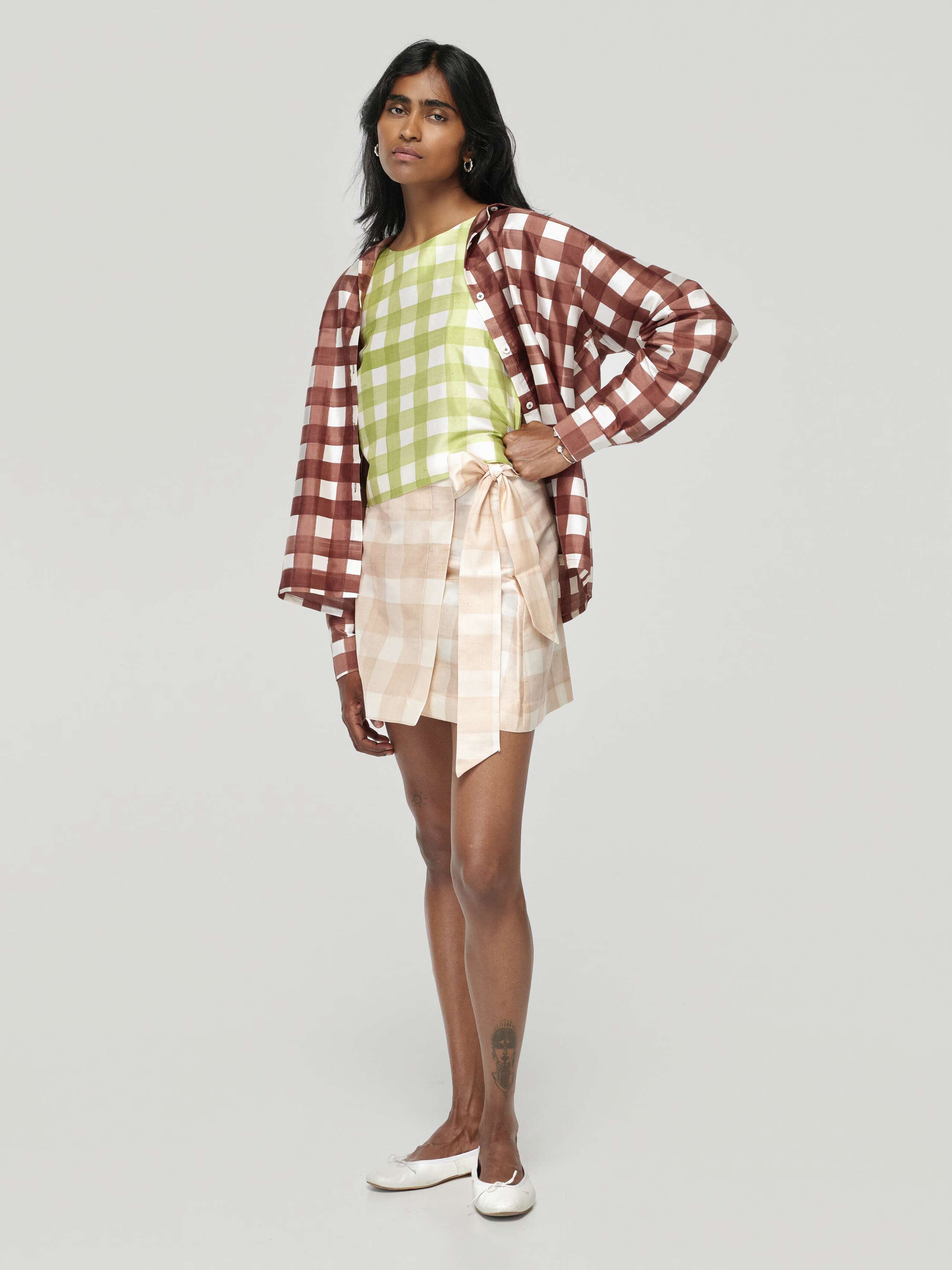 Model wearing Francesca blouse in palermo brown and Edina short skirt hand painted vichy in moonrock