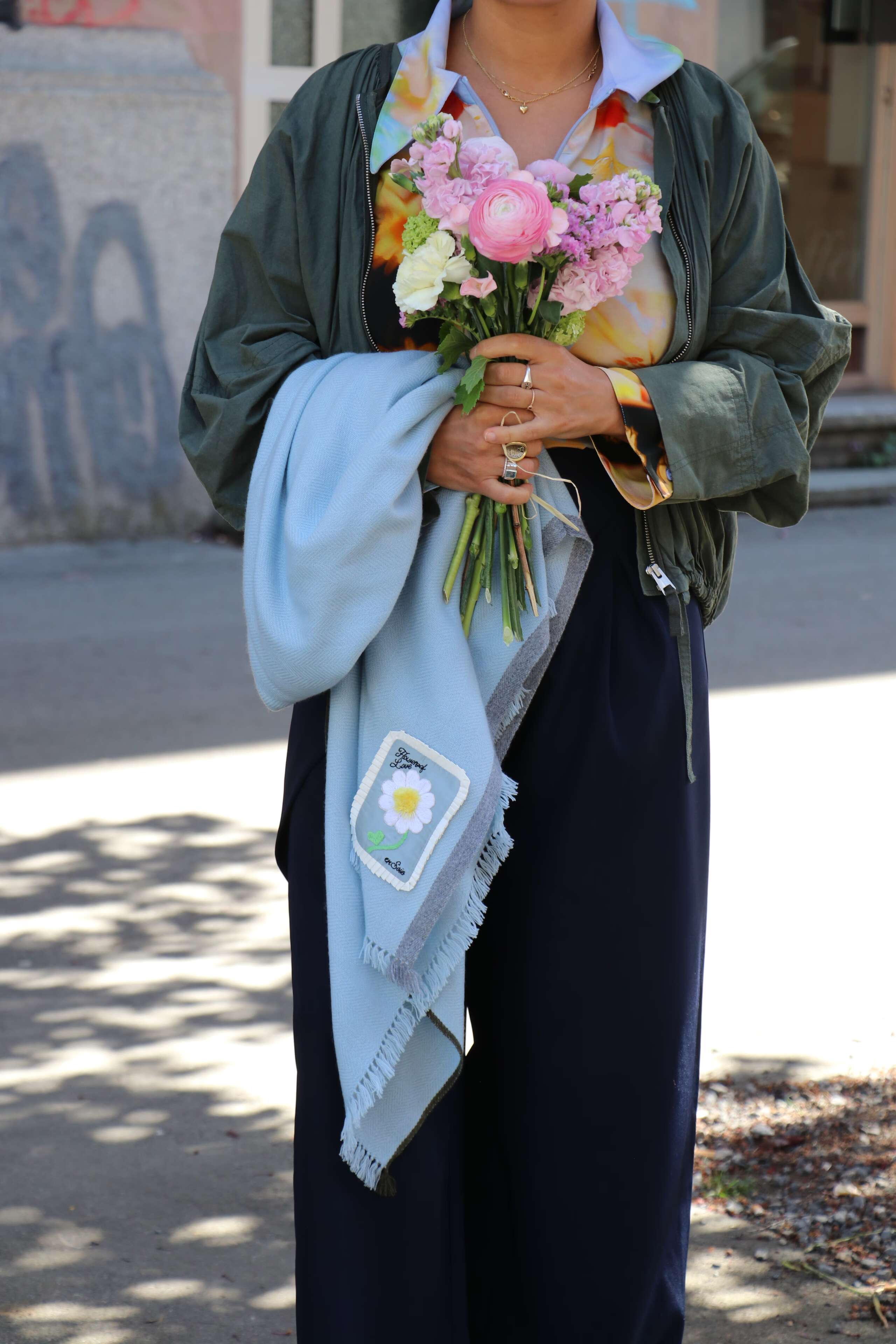 Picture of a women holding a flower bouquet wrapped in a yellow paper