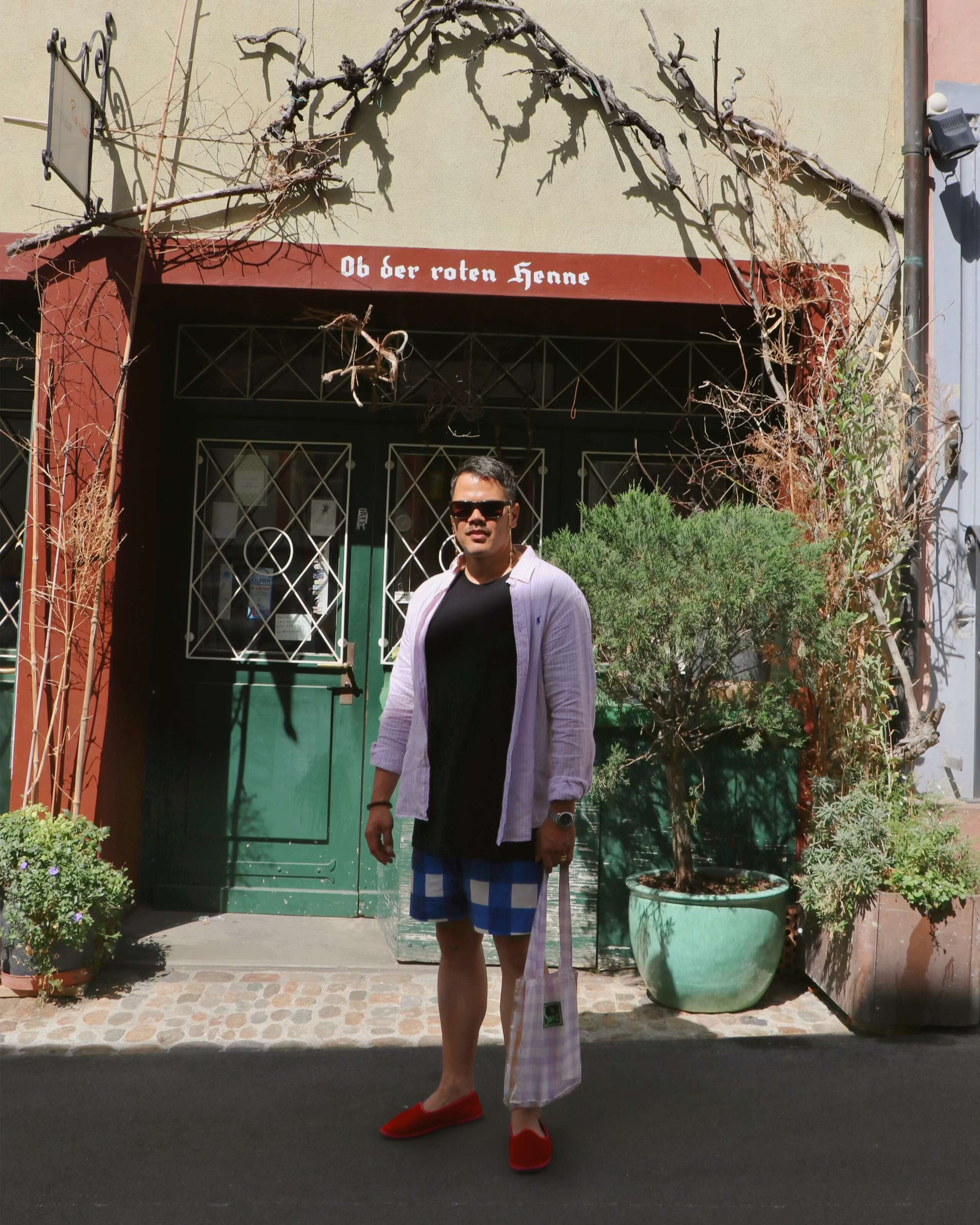 Picture of a man in front of a green door 