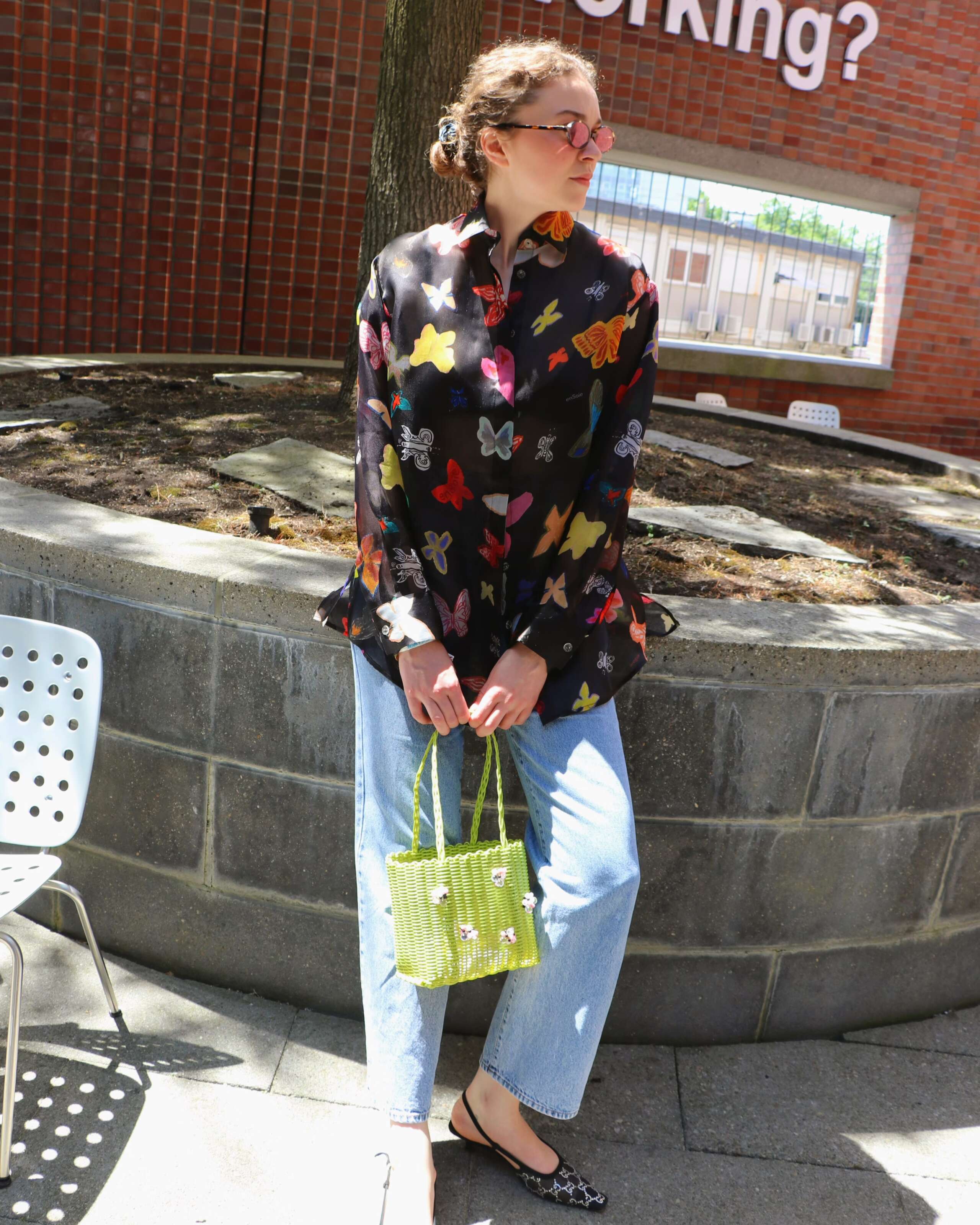 Picture of a young women in Basel wearing a colourful blouse from enSoie