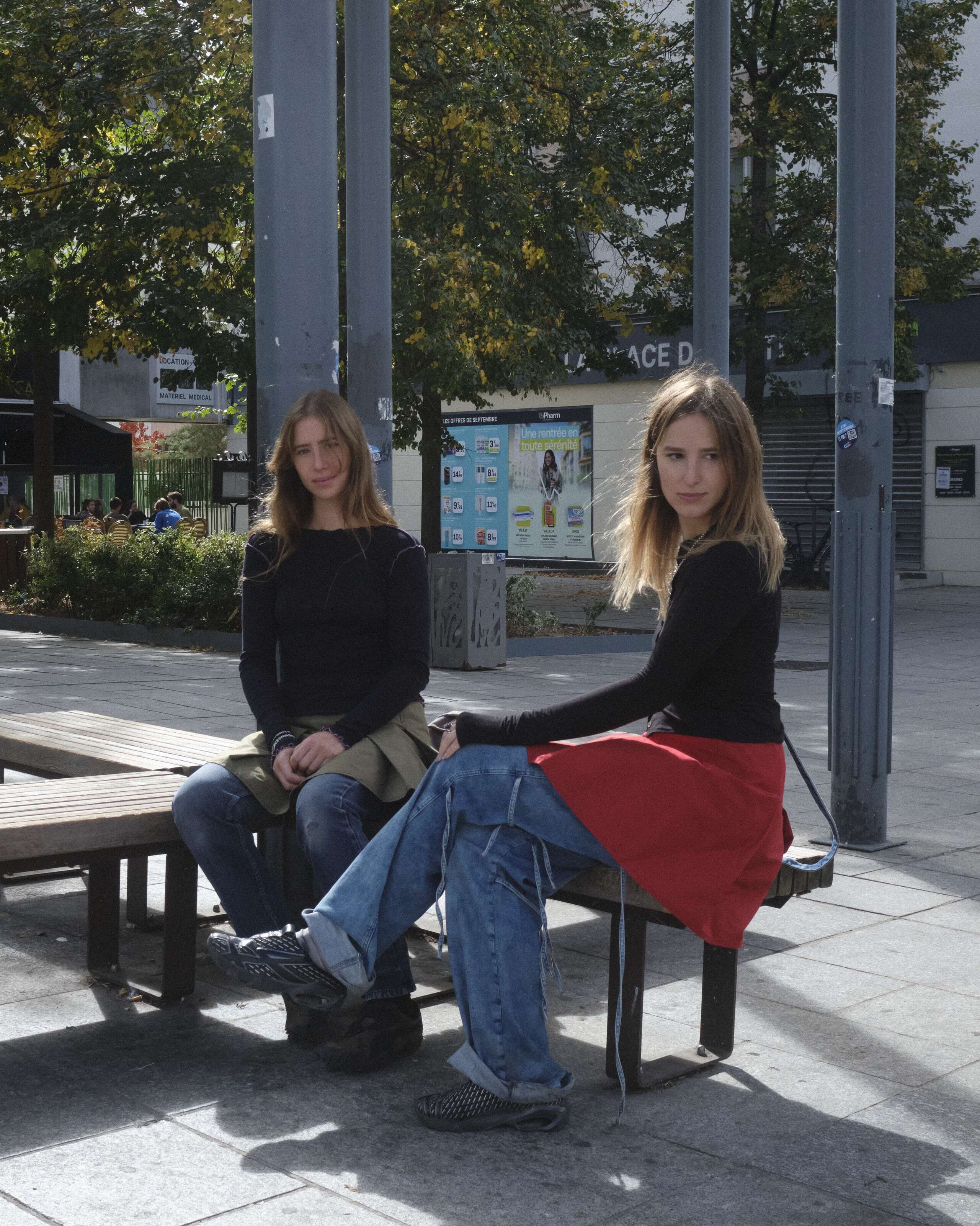 Two young women sitting in a park in Paris