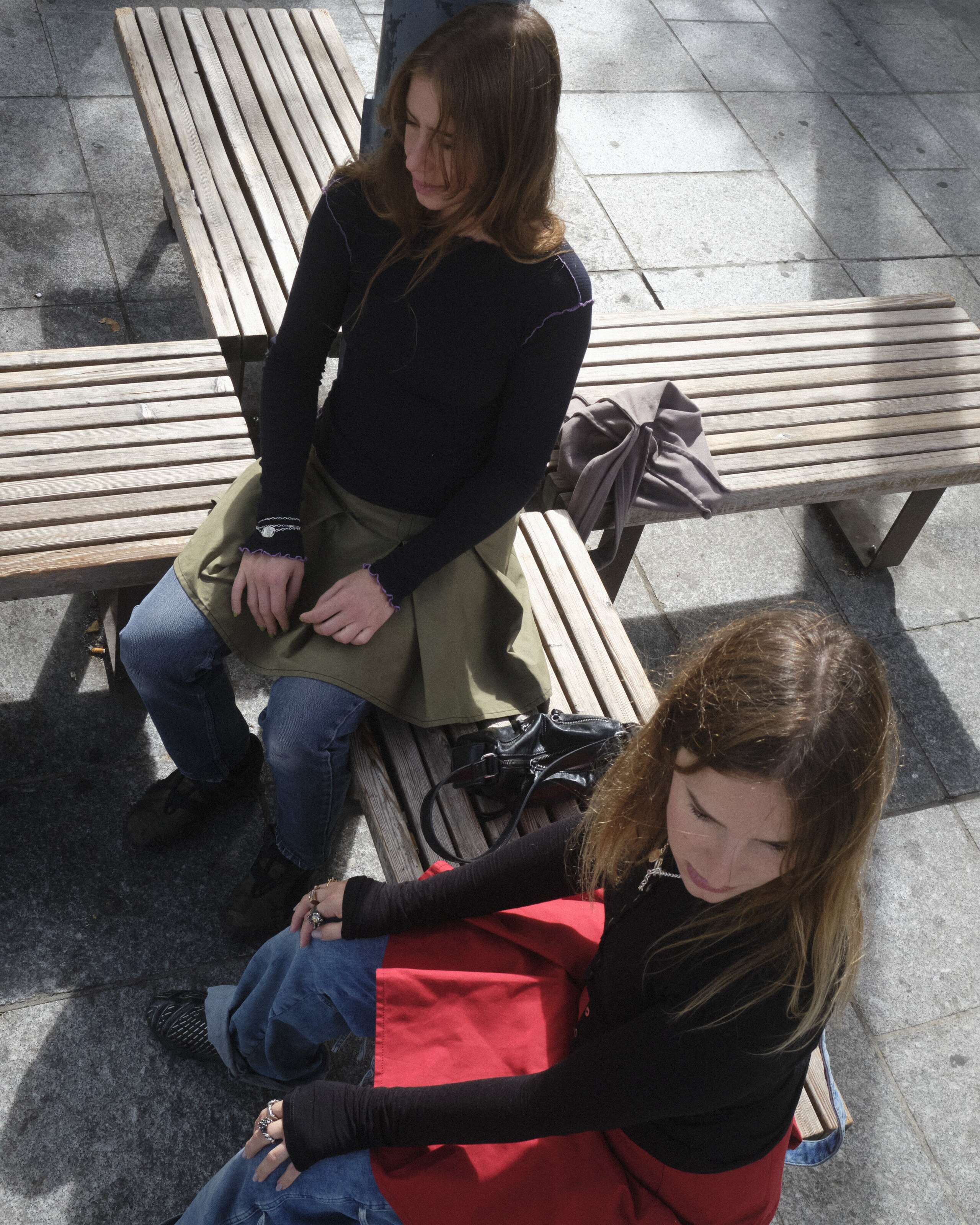 Two young women sitting in a park in Paris
